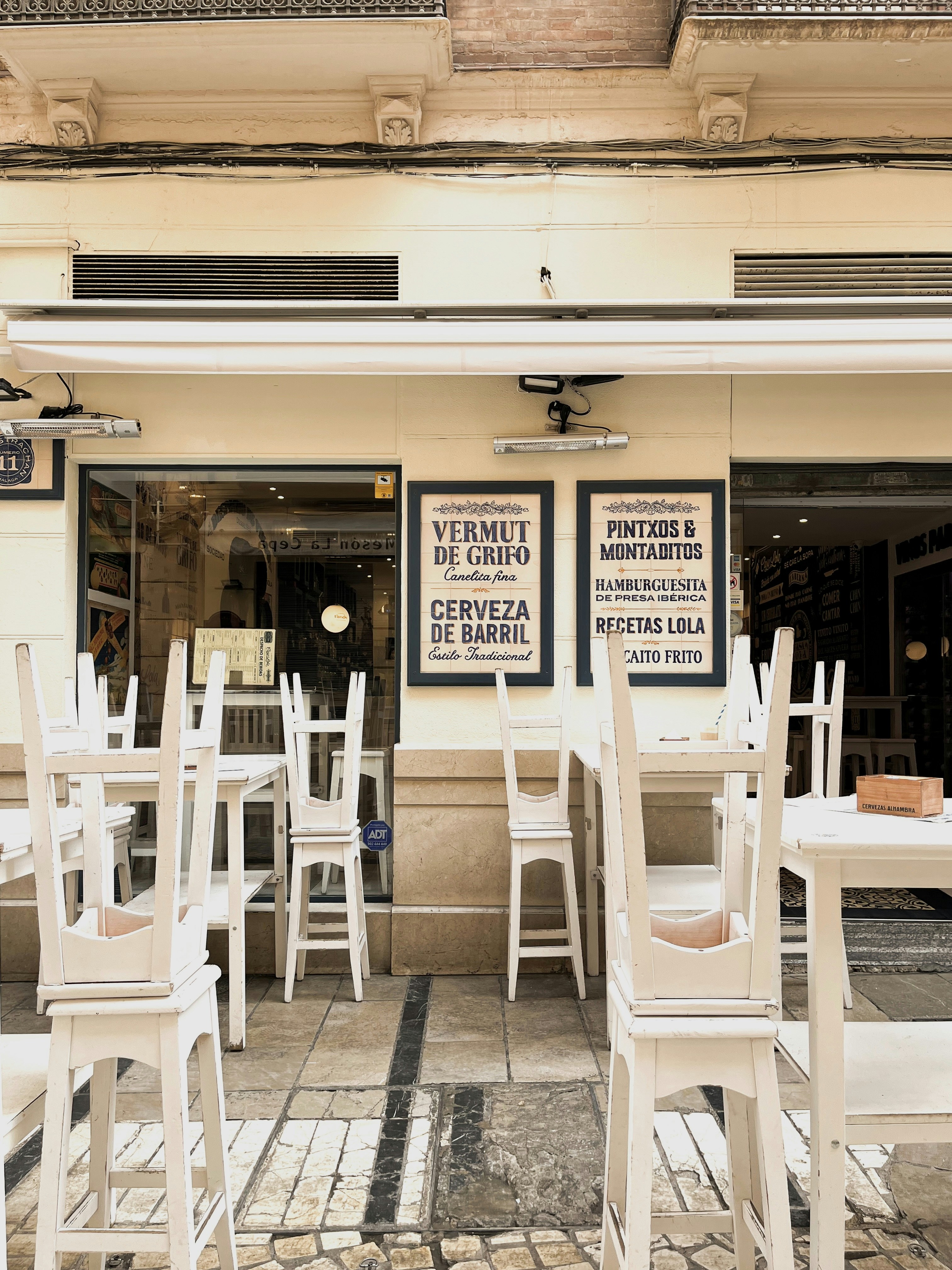 Outdoor cafe tables and chairs stacked high.