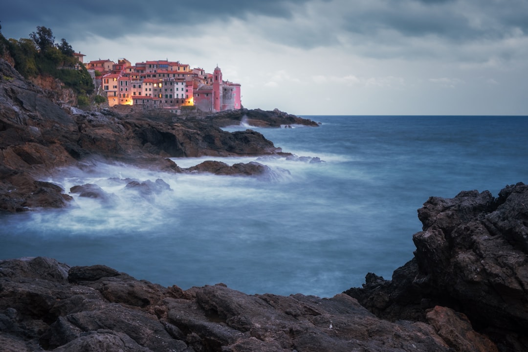 Coastal town with lights on the water at dusk.