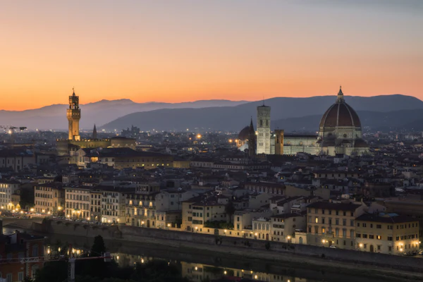 Florence's illuminated cathedral and city skyline at dusk