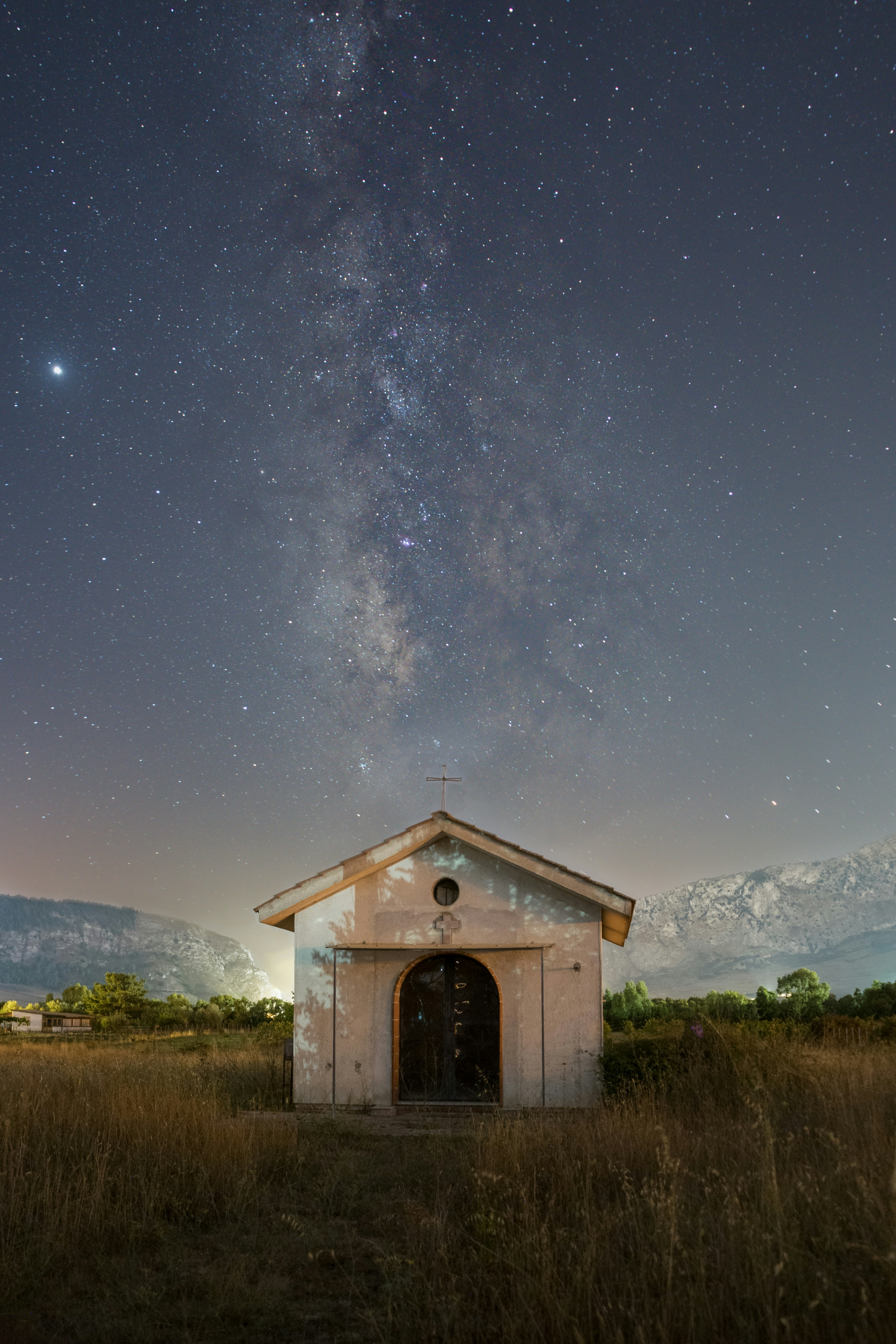 Small building under the milky way galaxy.