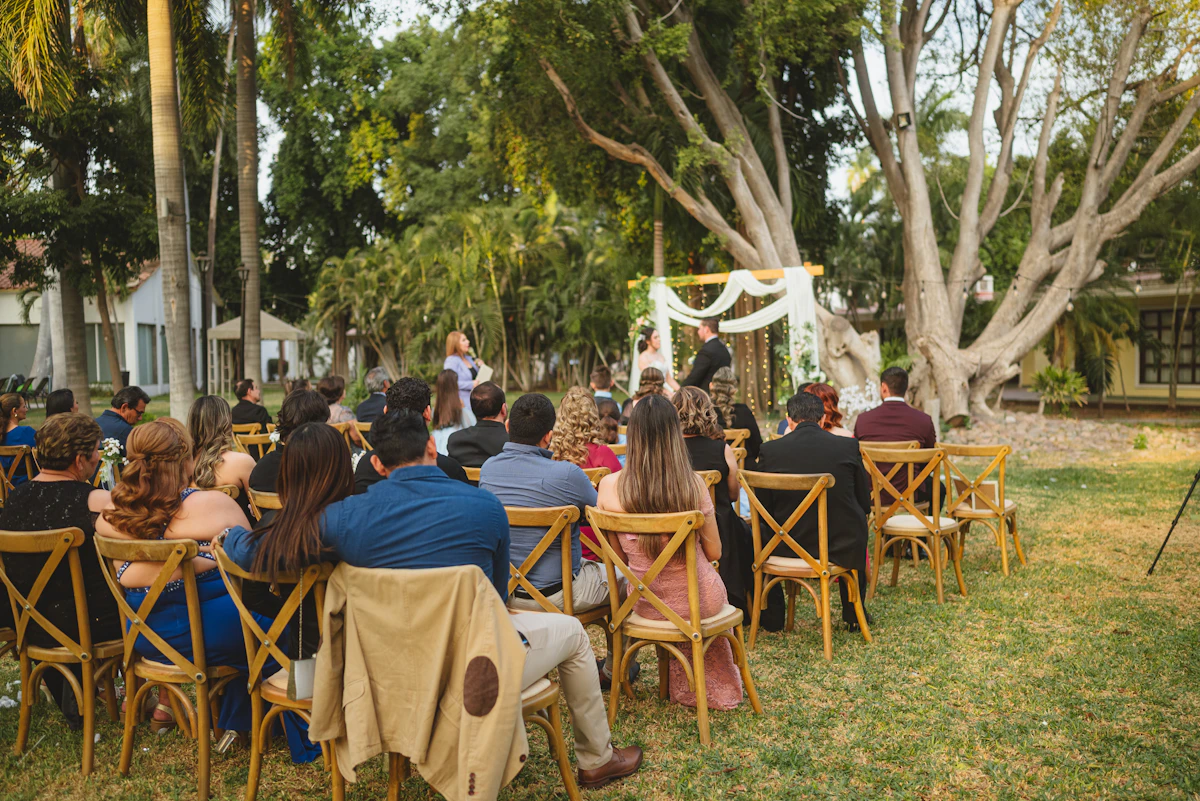 Guests seated at an outdoor wedding ceremony