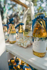 Bottles with golden caps and blue ribbons on shelf