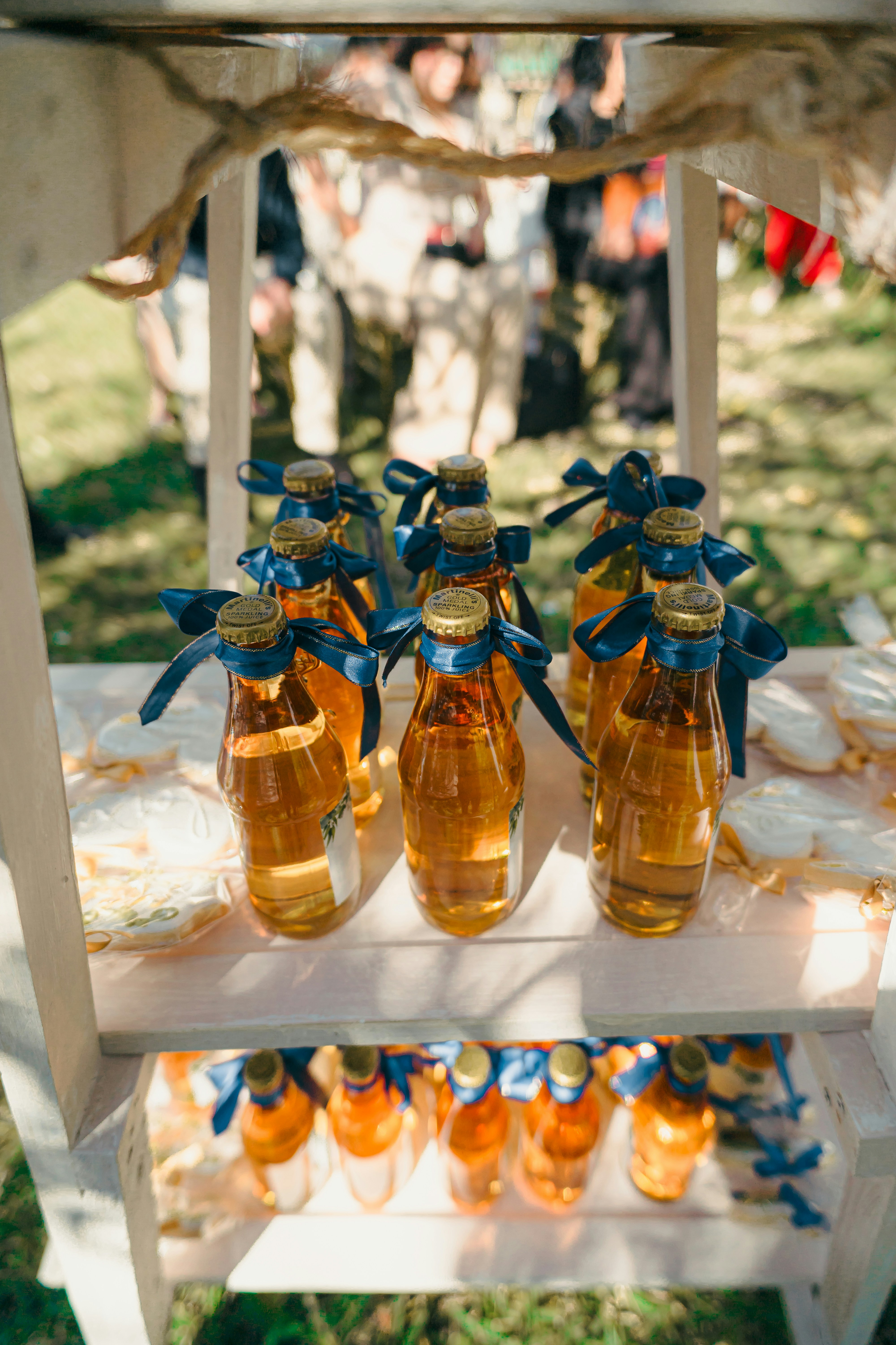 Bottles of amber liquid with blue ribbons