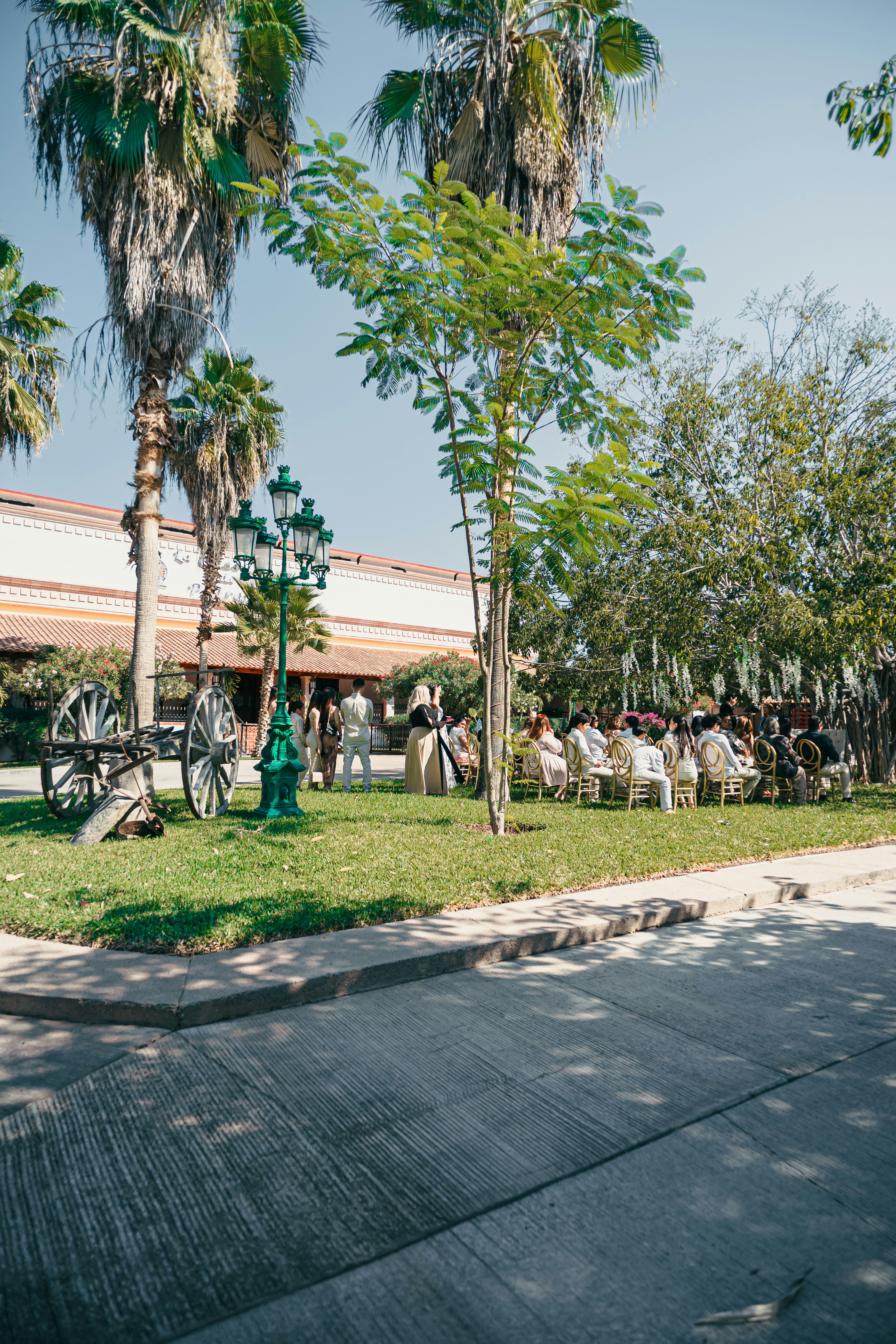 Outdoor wedding ceremony with guests seated on lawn.