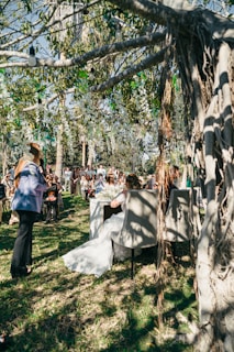 Bride sitting at table during outdoor wedding ceremony