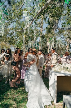 Bride hugging guests at outdoor wedding ceremony