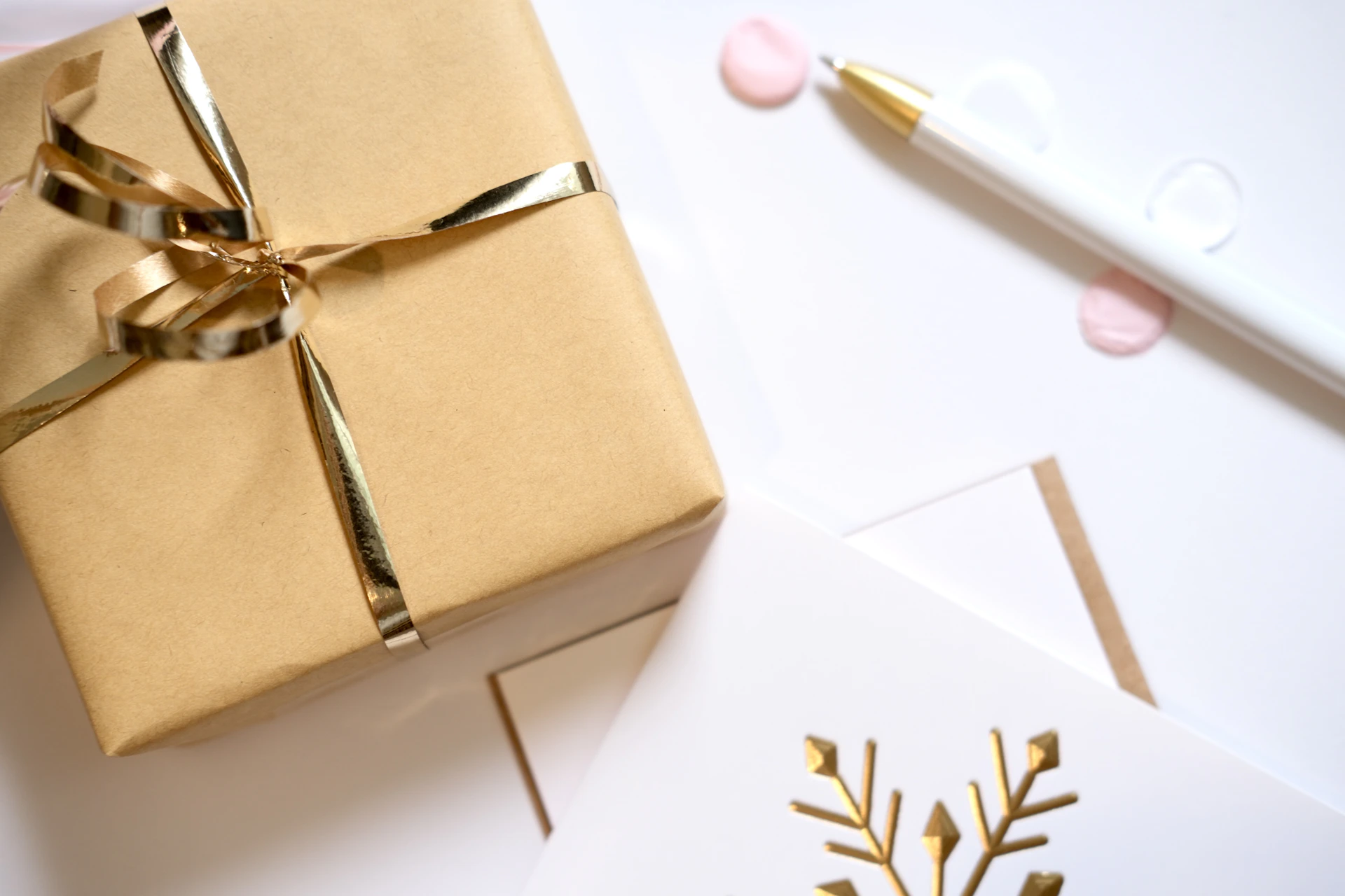Gift wrapped in gold ribbon with holiday cards