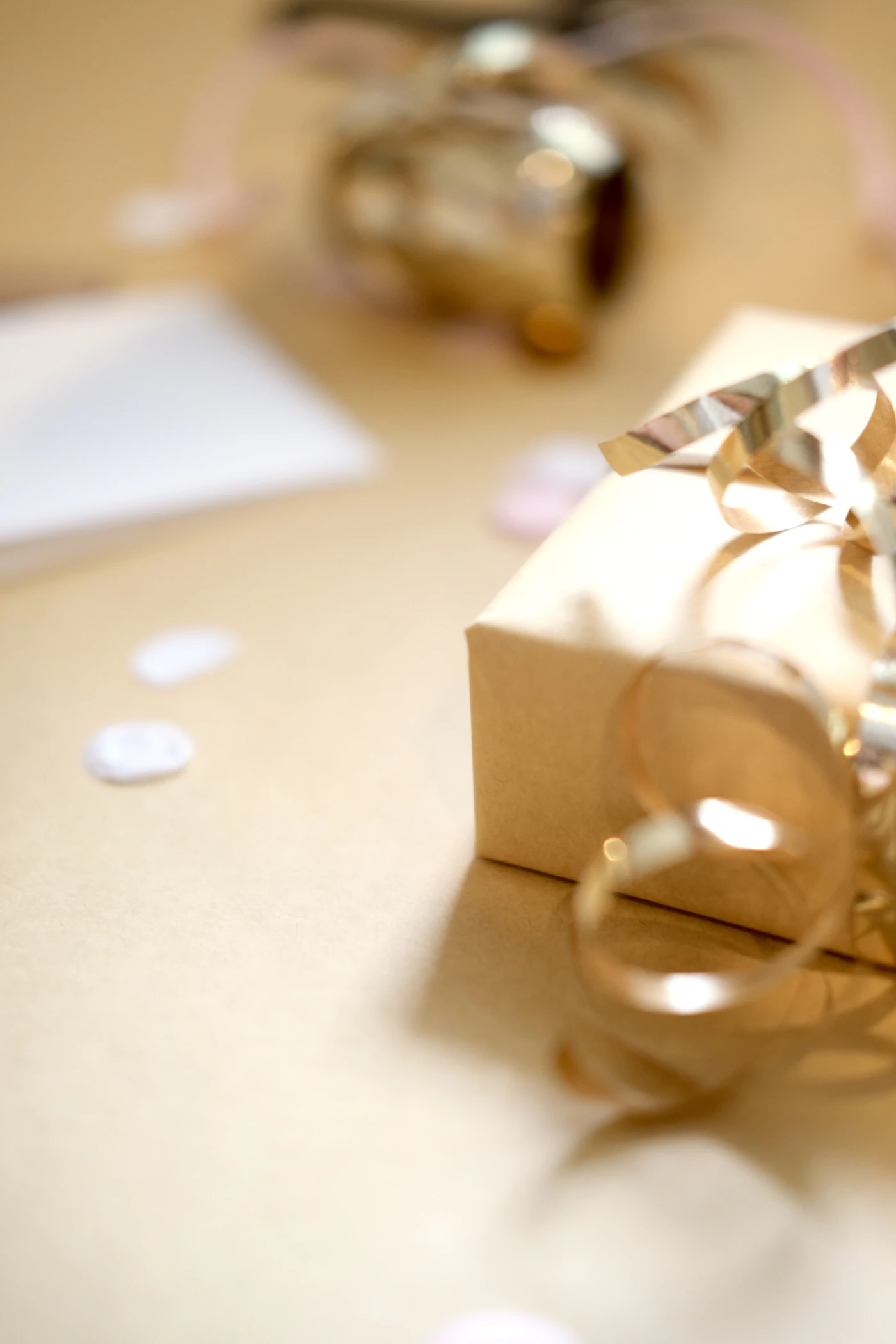 Celebration gift box finished with a golden ribbon and confetti