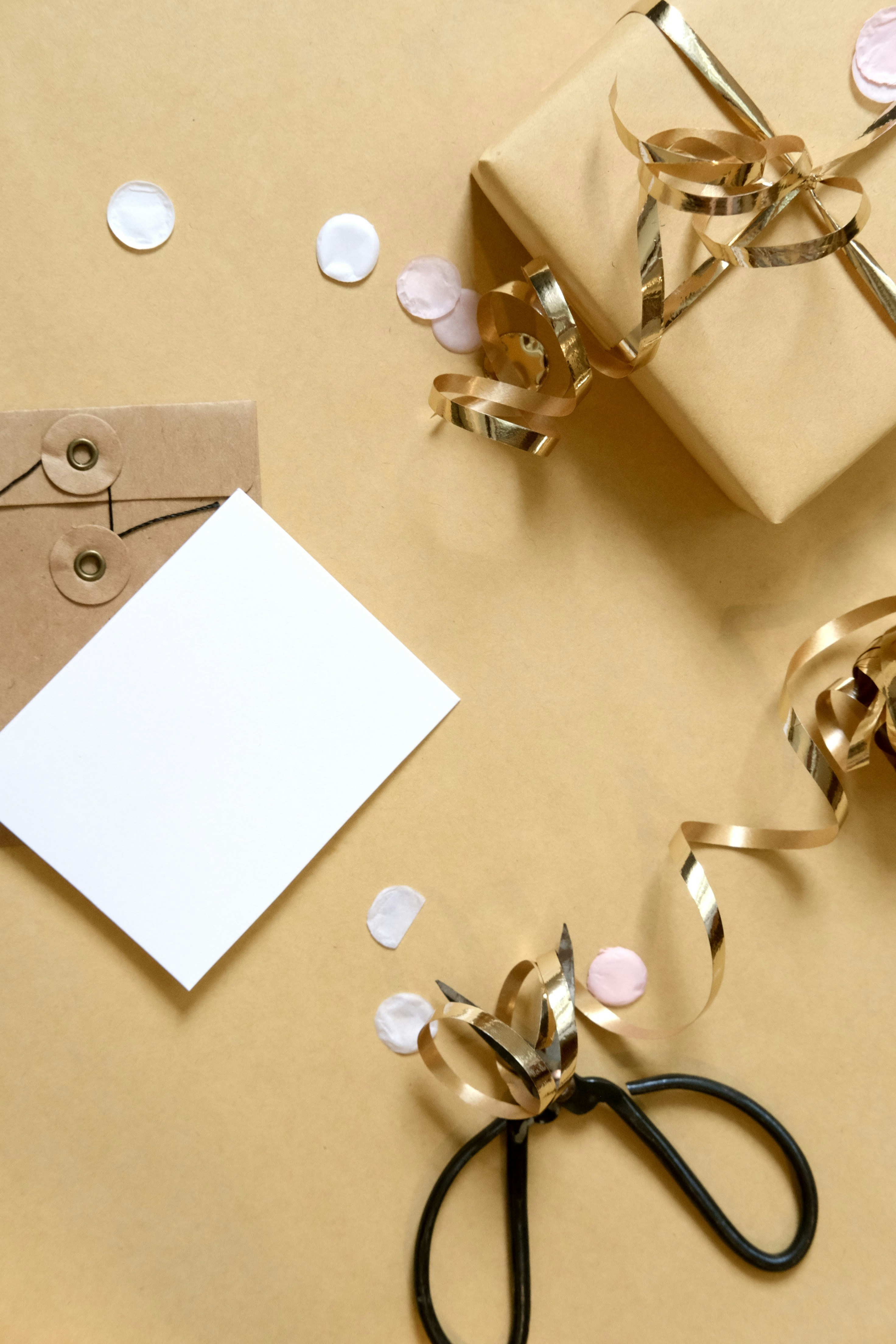 Gift box with ribbon, card, and confetti