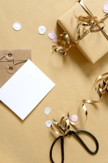 Gift box with ribbon, card, and confetti