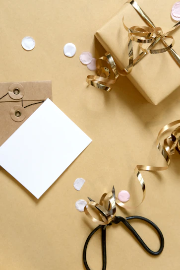 Gift box with ribbon, card, and confetti