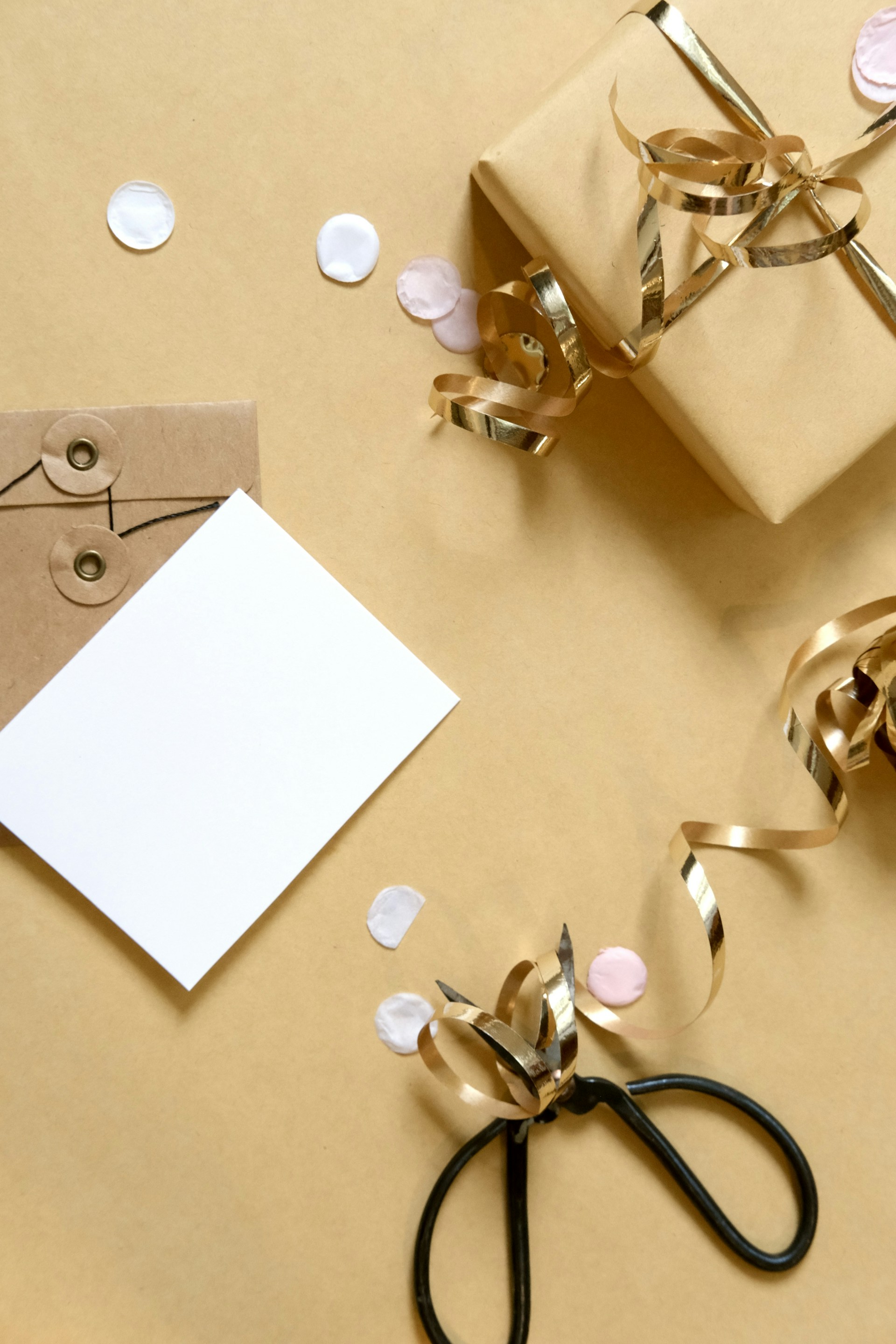 Gift box with ribbon, card, and confetti