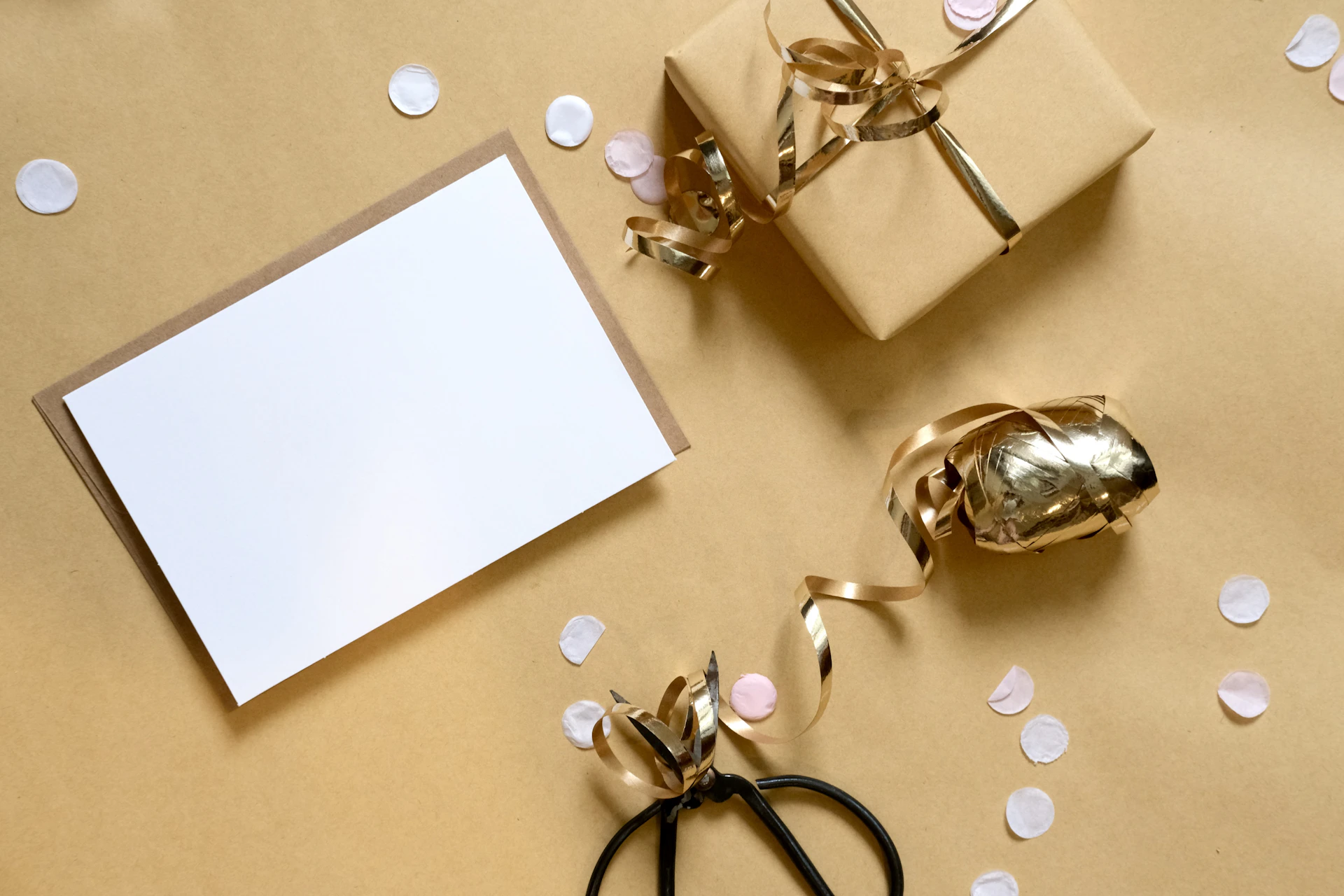 Gift box with blank card and confetti on gold background