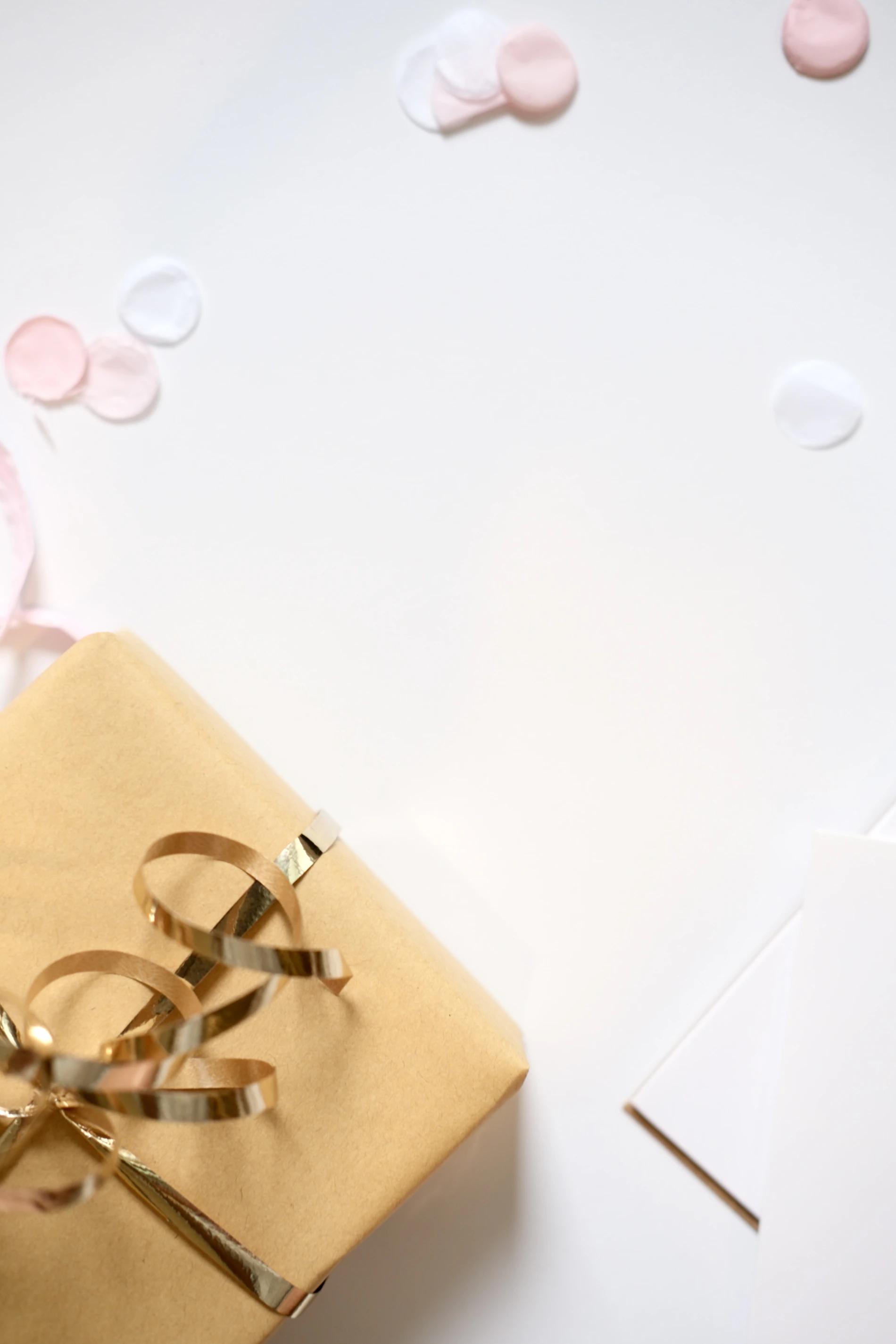 Gift box finished with gold ribbon and celebration confetti