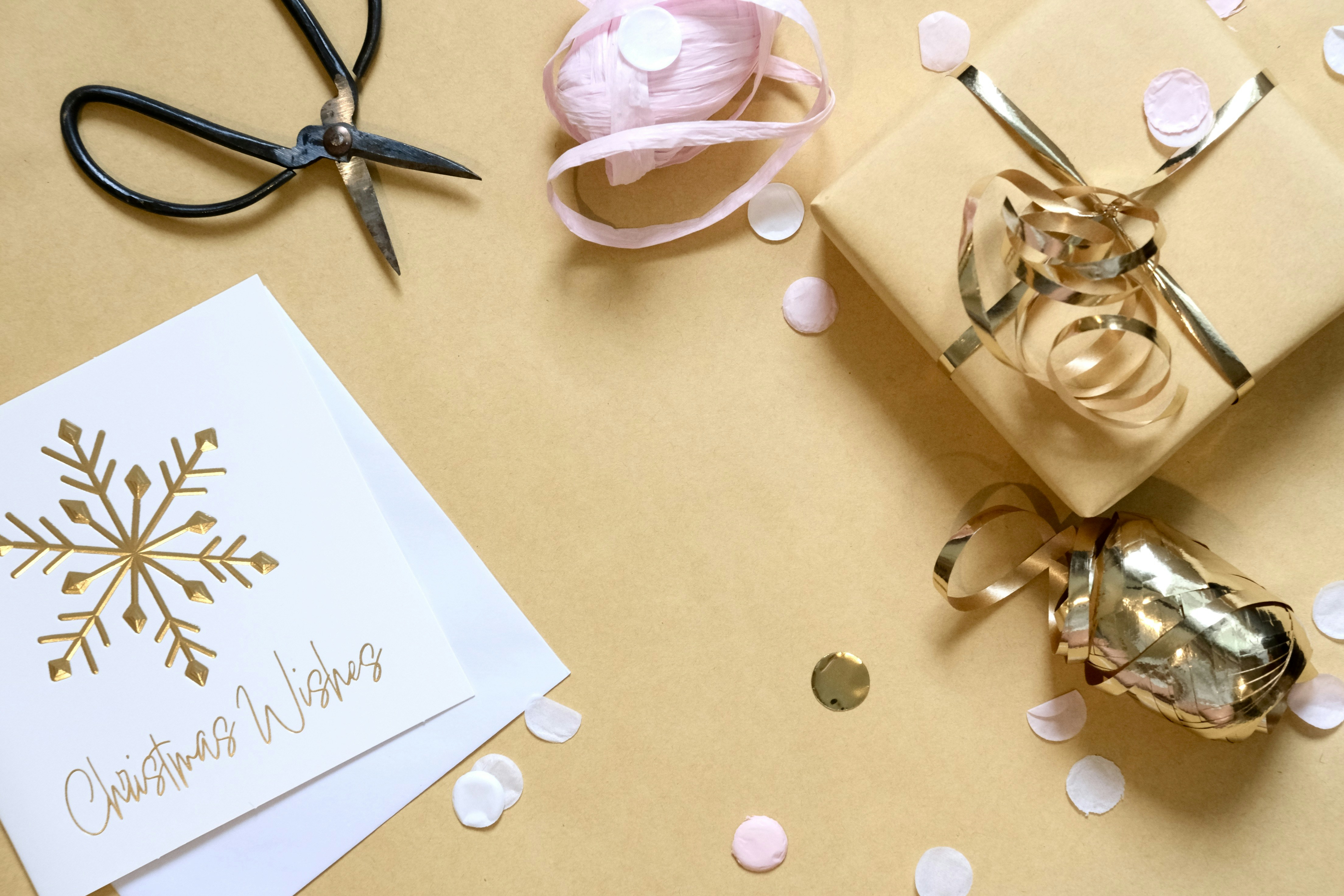 Gift wrapping with card, scissors, and ribbon