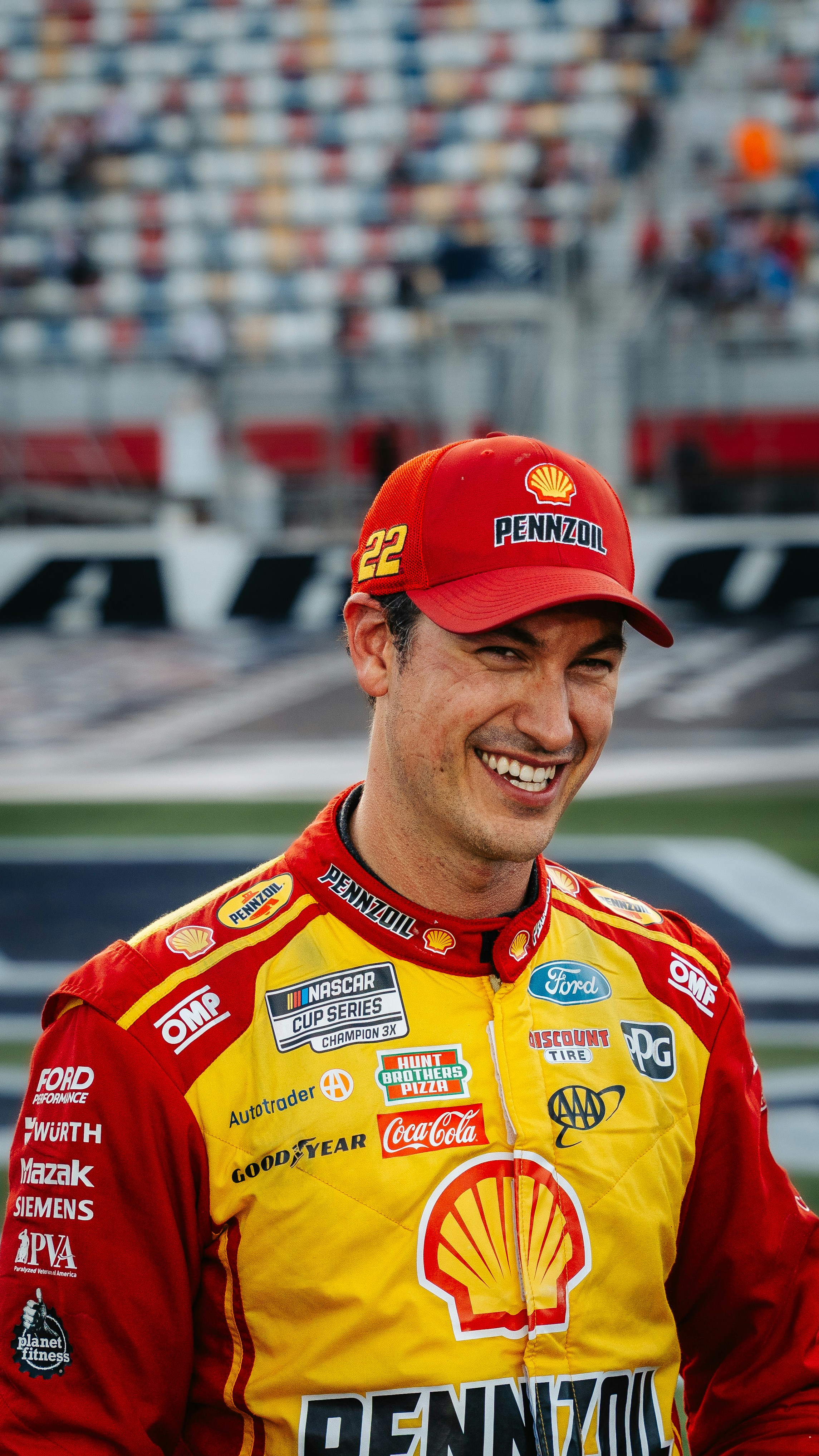 Nascar driver joey logano smiles on the track