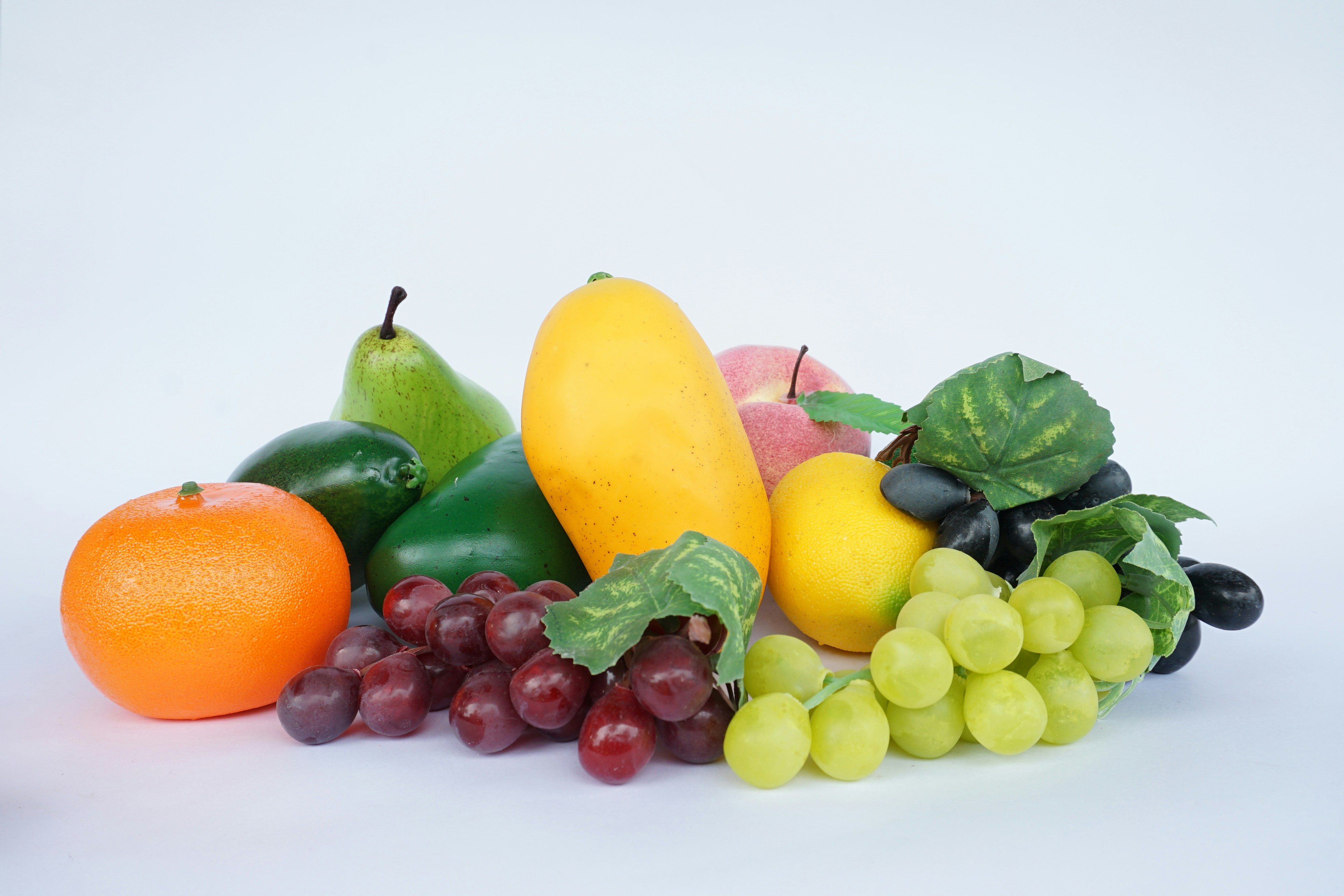 Assorted fresh fruits including grapes, mango, and orange.