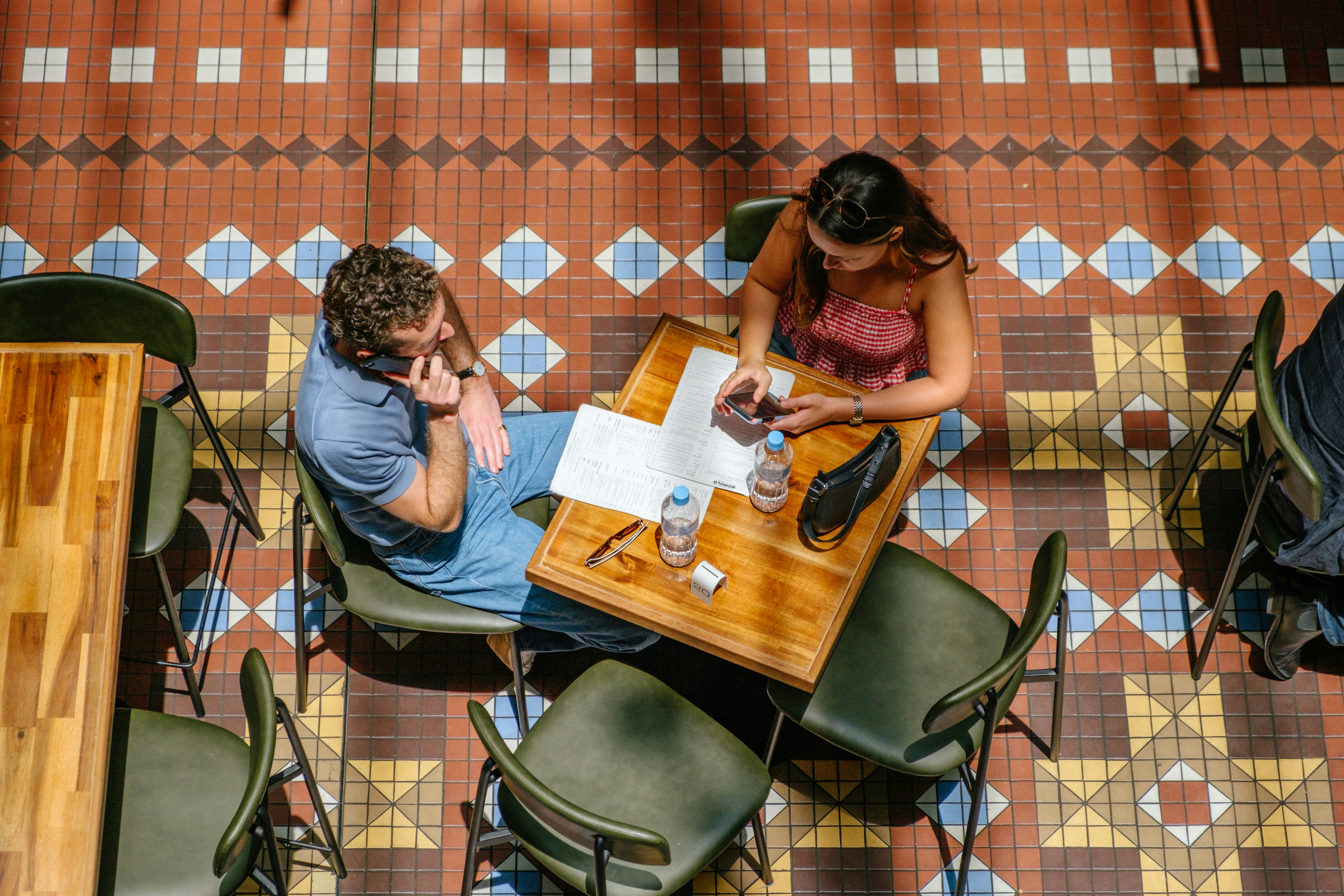 two people sitting at a cafe table