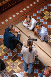 Four people gathered around a long wooden table