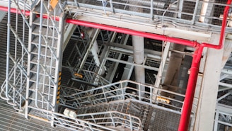 Industrial structure with metal stairs and red pipes