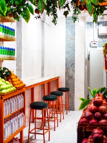 Juice bar counter with fruits and stools