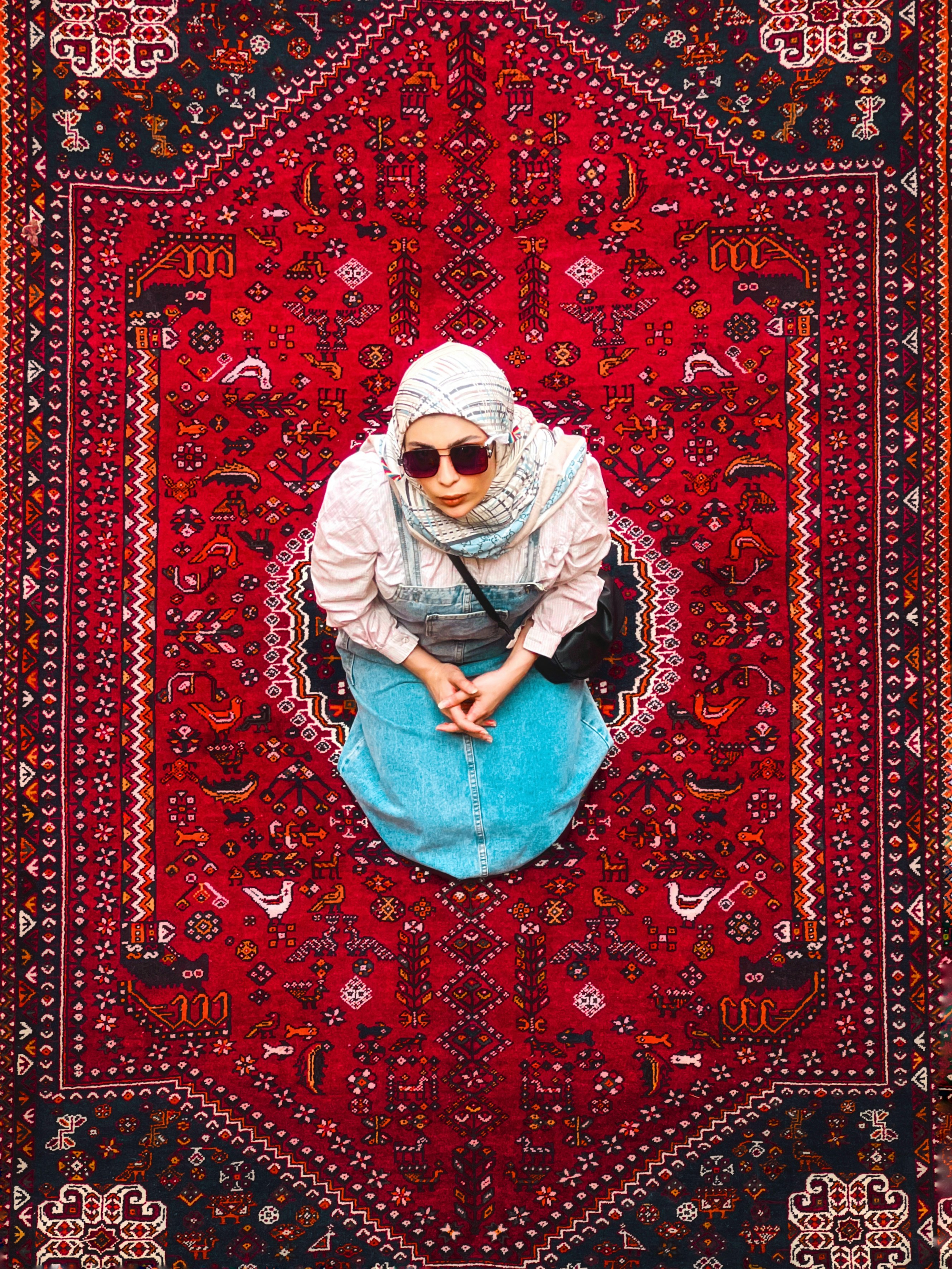 Woman kneeling on a patterned persian rug