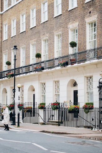 Elegant georgian townhouses with ornate balconies and flowers.