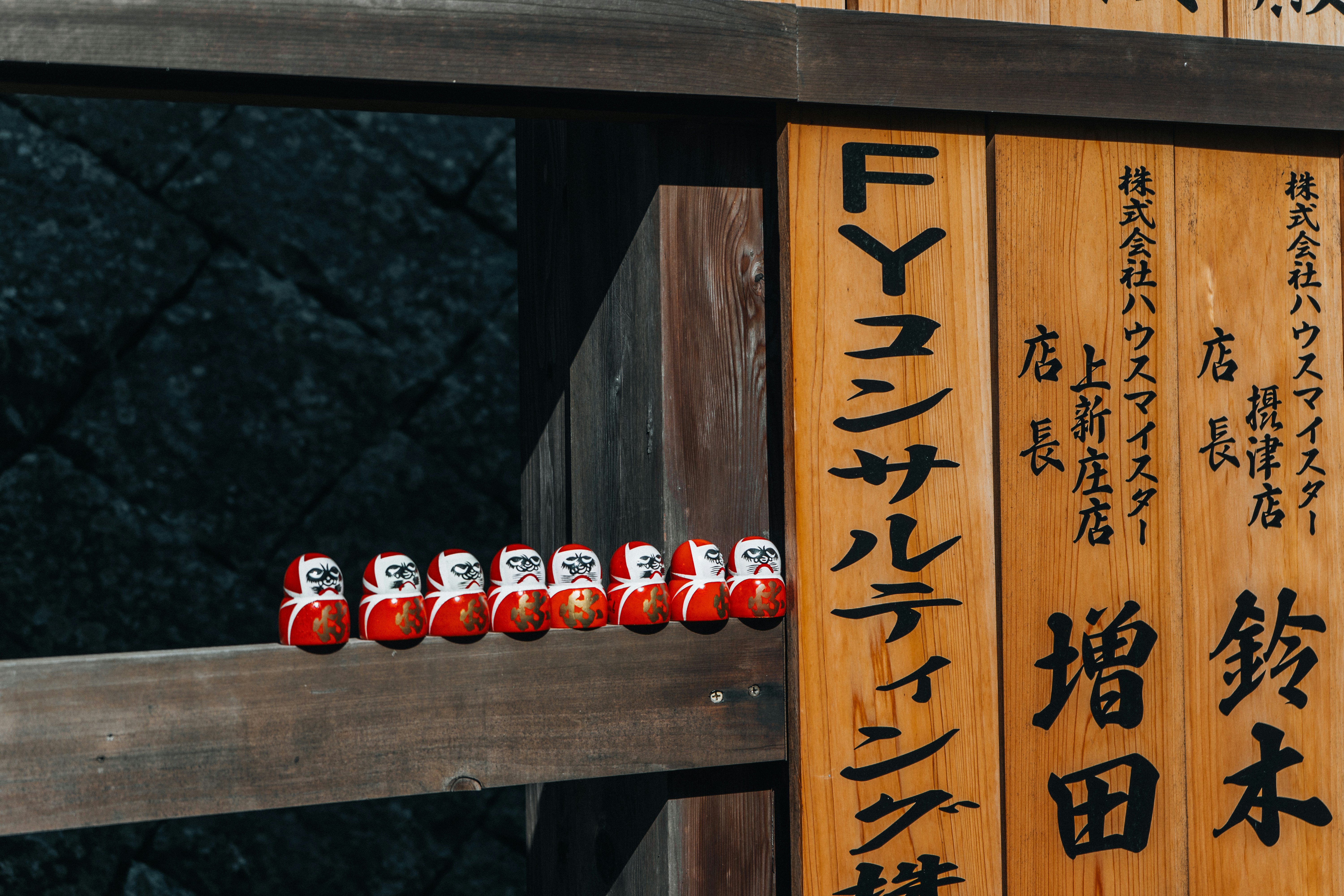A collection of small figurines photographed at Katsuo-ji Temple in Osaka, Japan. The statues are captured from multiple angles, showcasing their detailed craftsmanship, traditional design, and placement within the temple grounds.