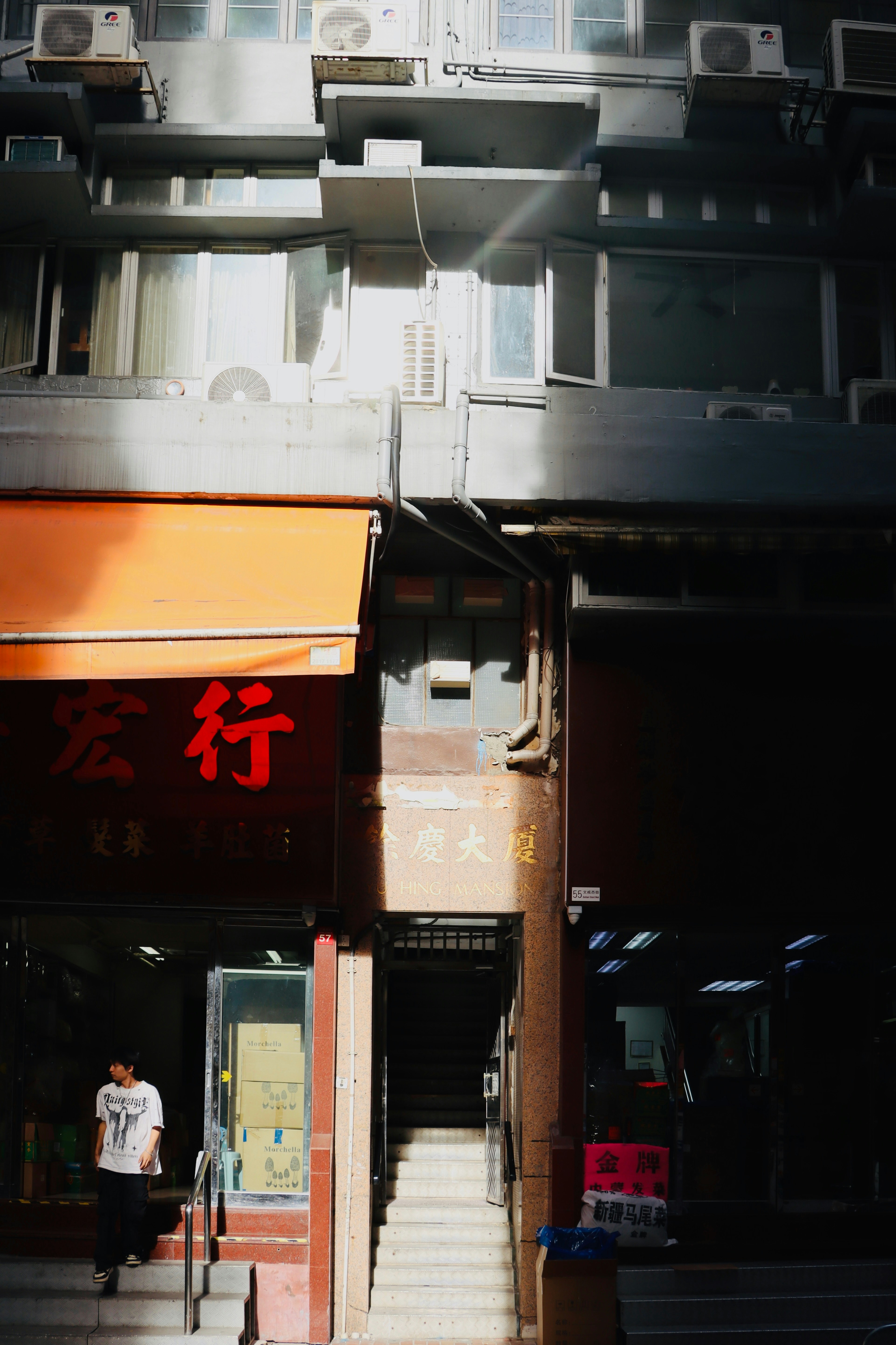 Man walking down stairs between buildings