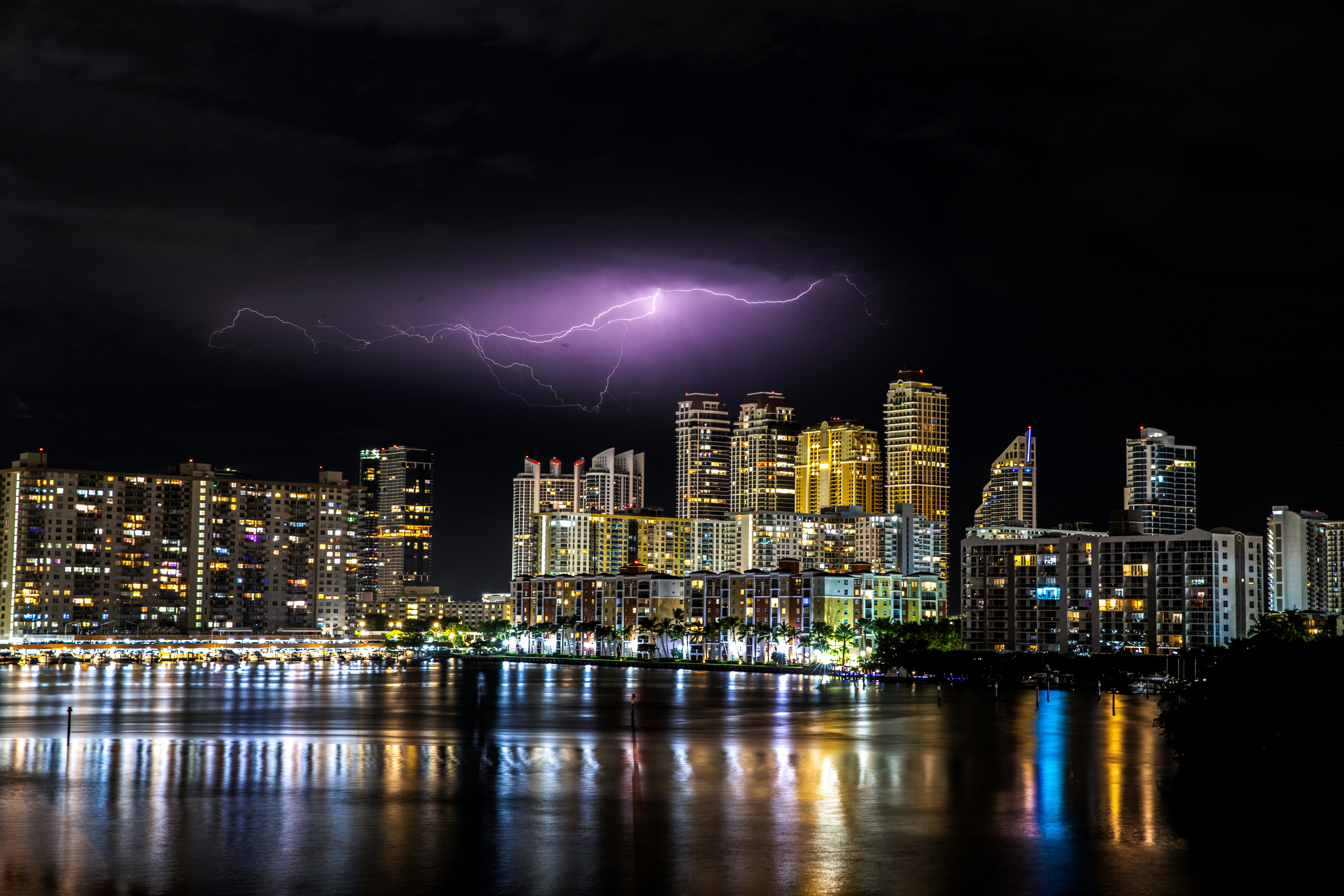 Lightning strikes over a city skyline at night