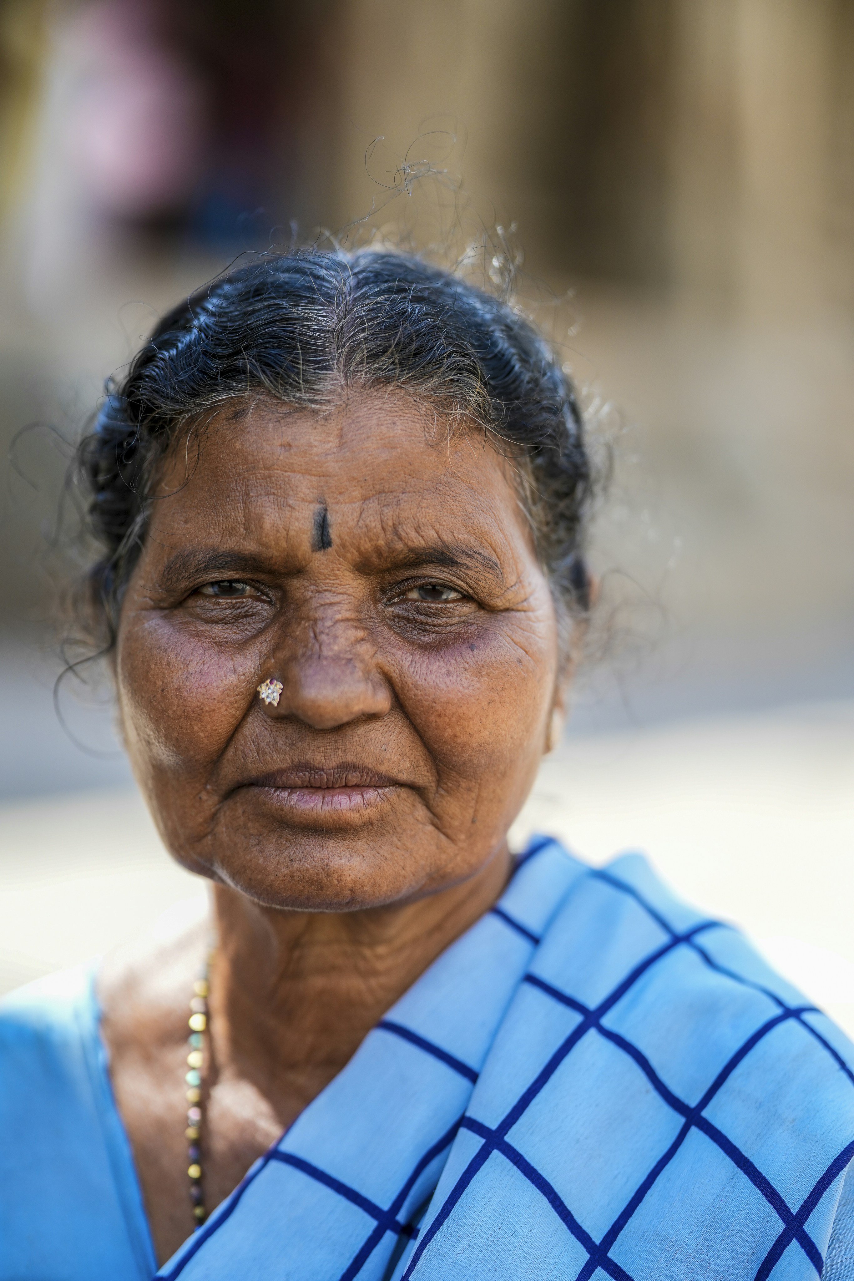 Elderly indian woman with a blue scarf