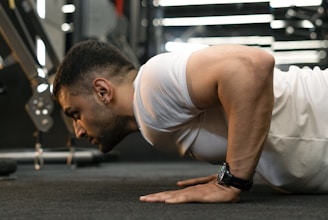 Man doing push-ups in a gym.