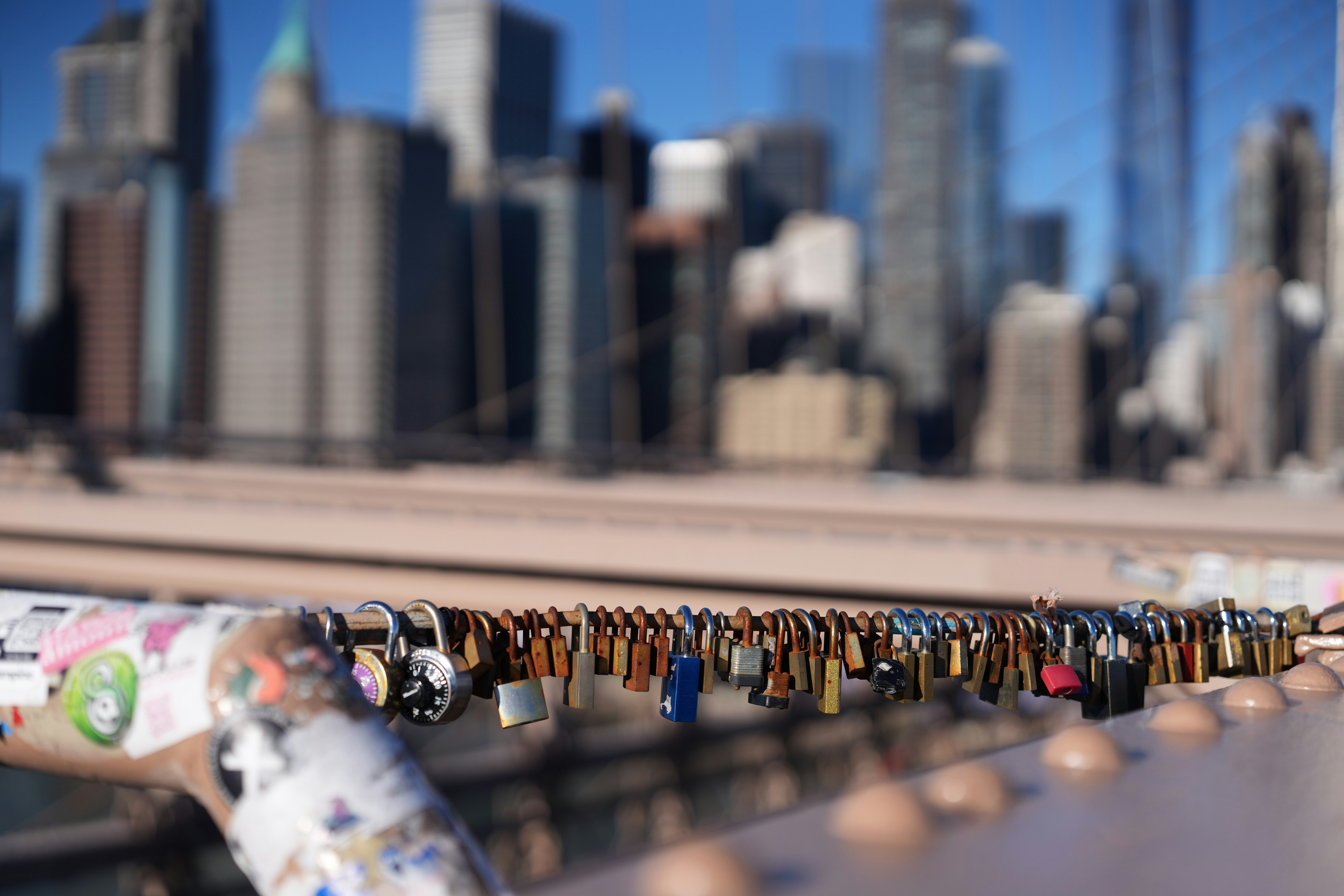 Love locks on a bridge with city skyline