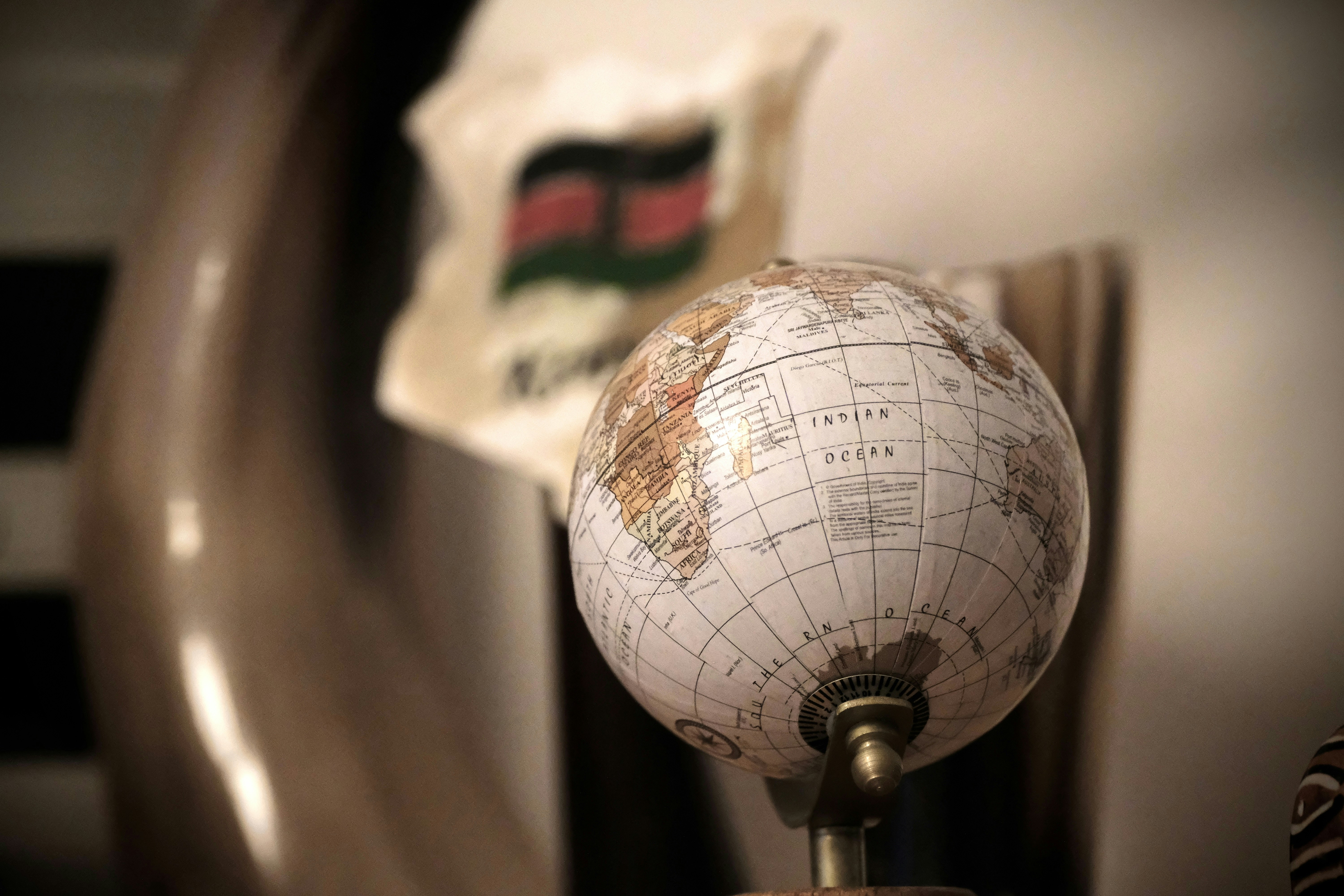 Small globe with a flag in background