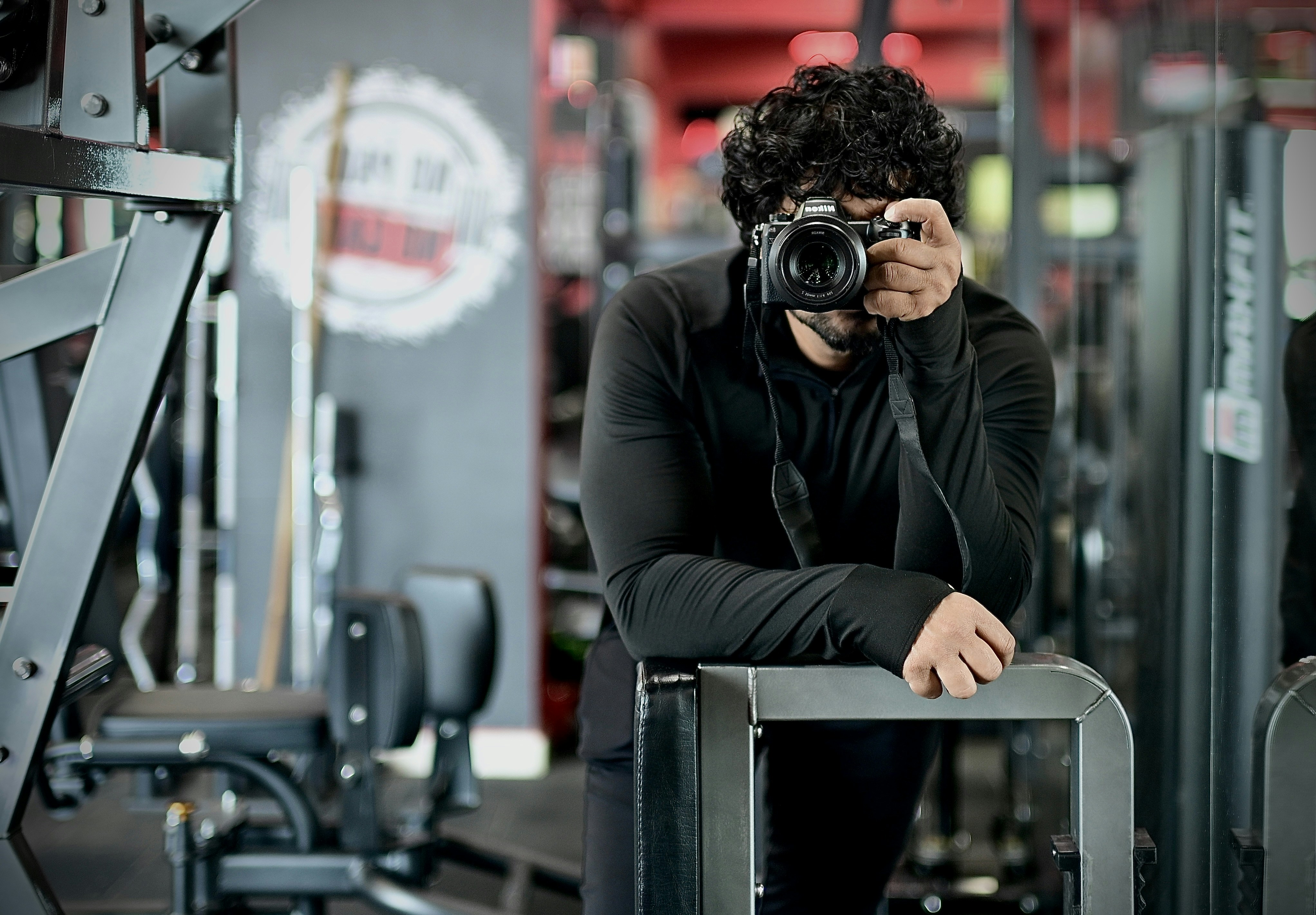 Man with camera taking selfie in gym