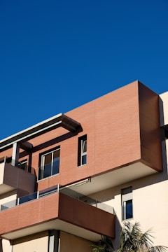 Modern building with balconies against clear blue sky