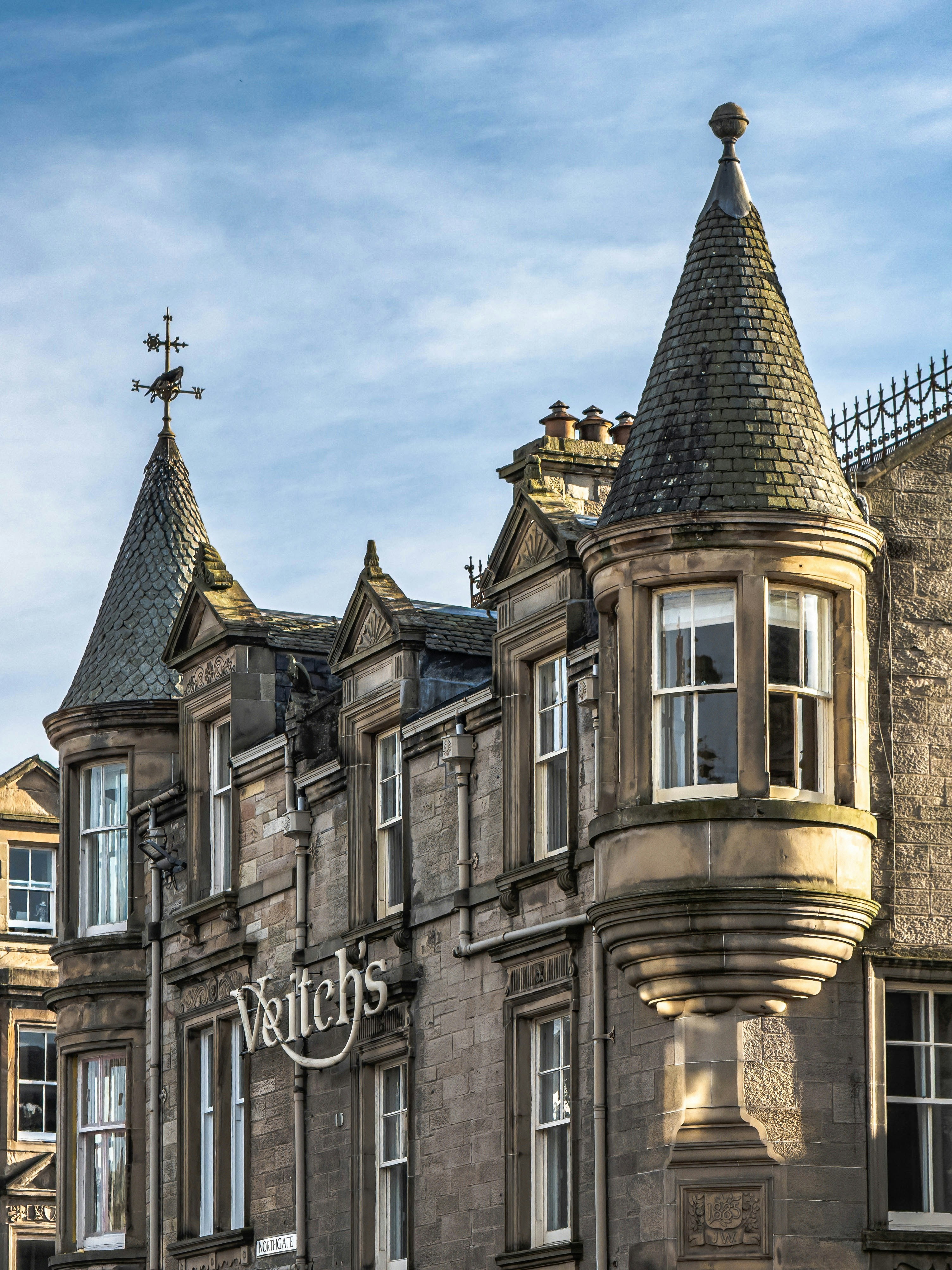 Historic building with ornate turrets and signage.