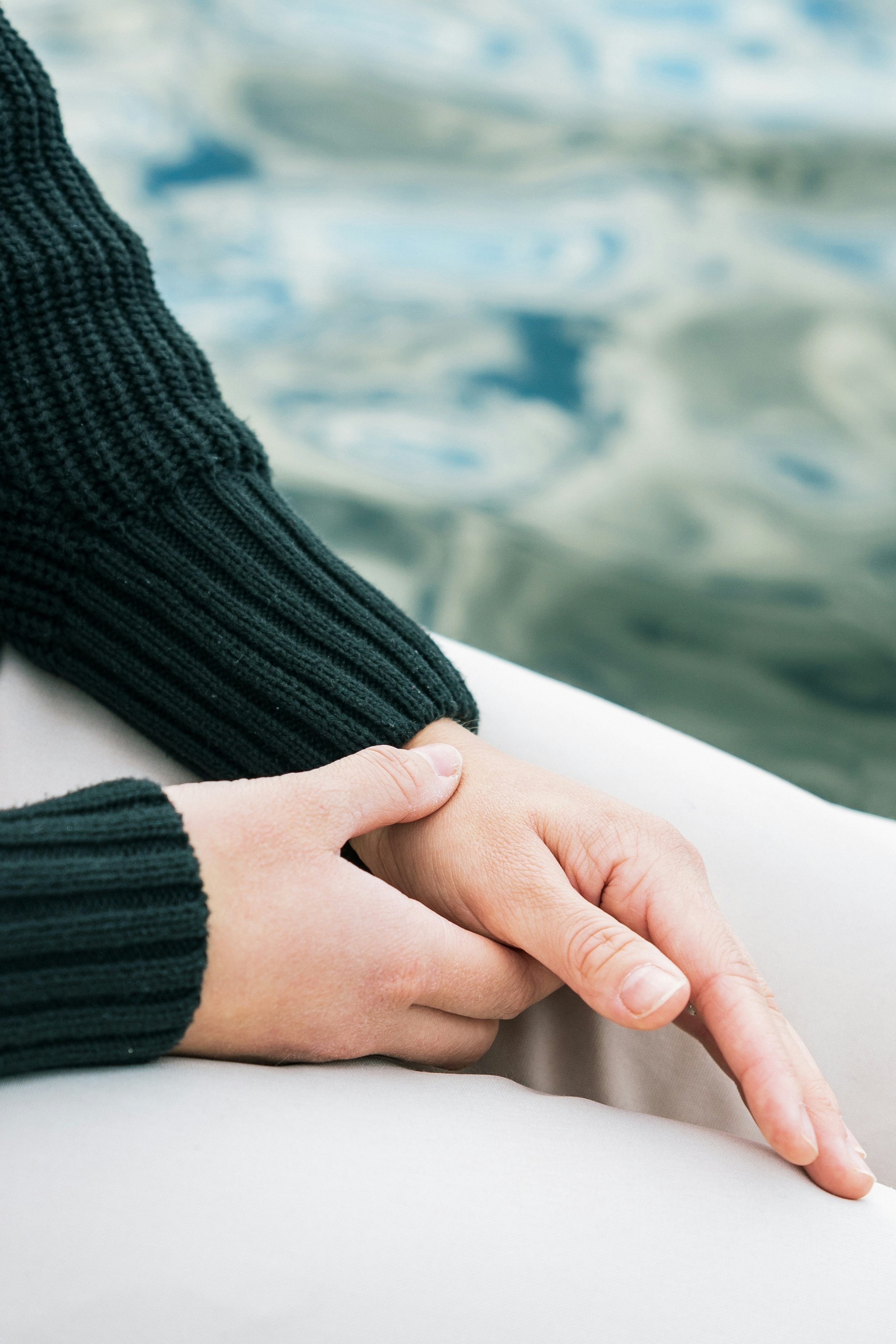 Two hands resting gently near water