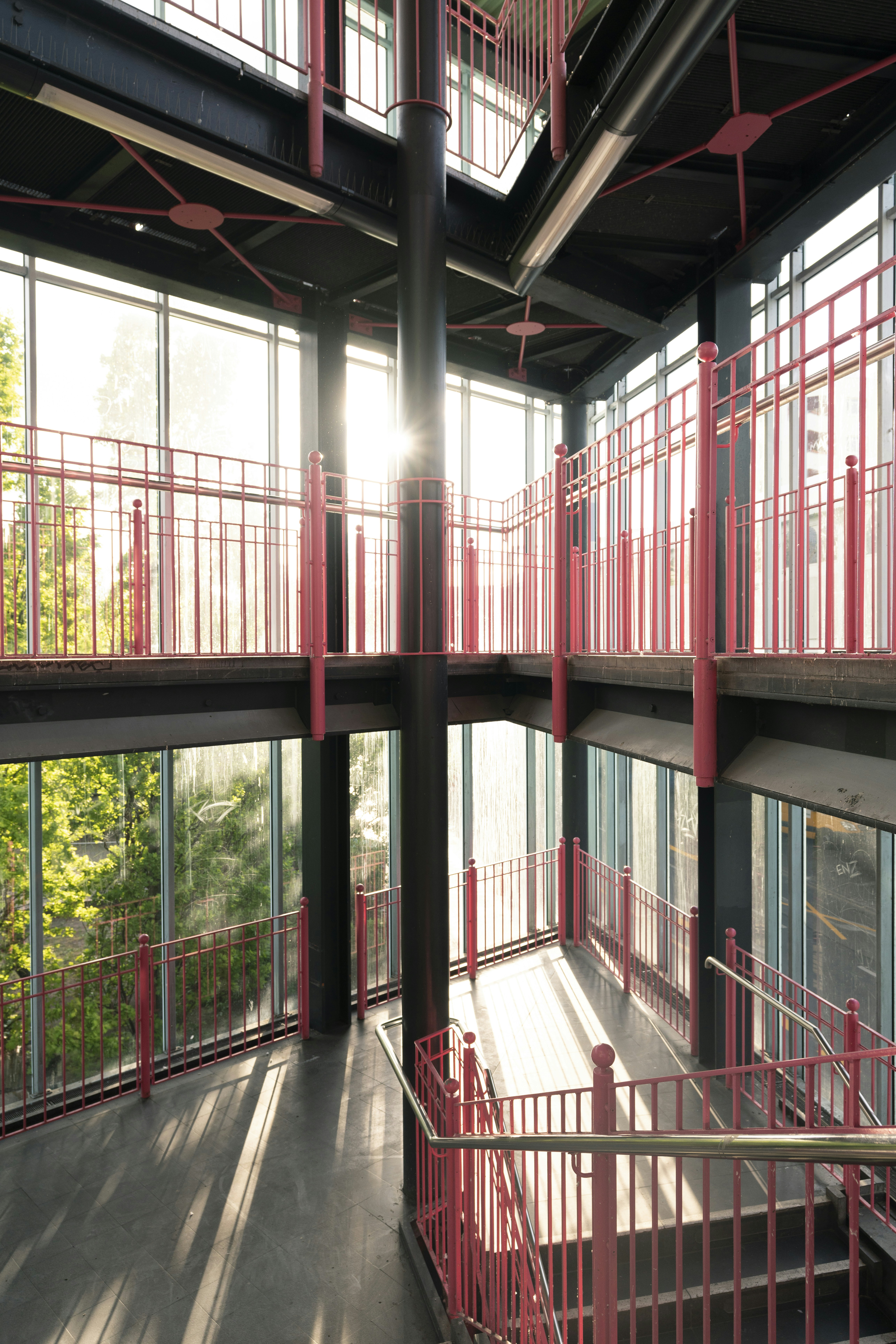Modern building interior with sunlit walkways and railings