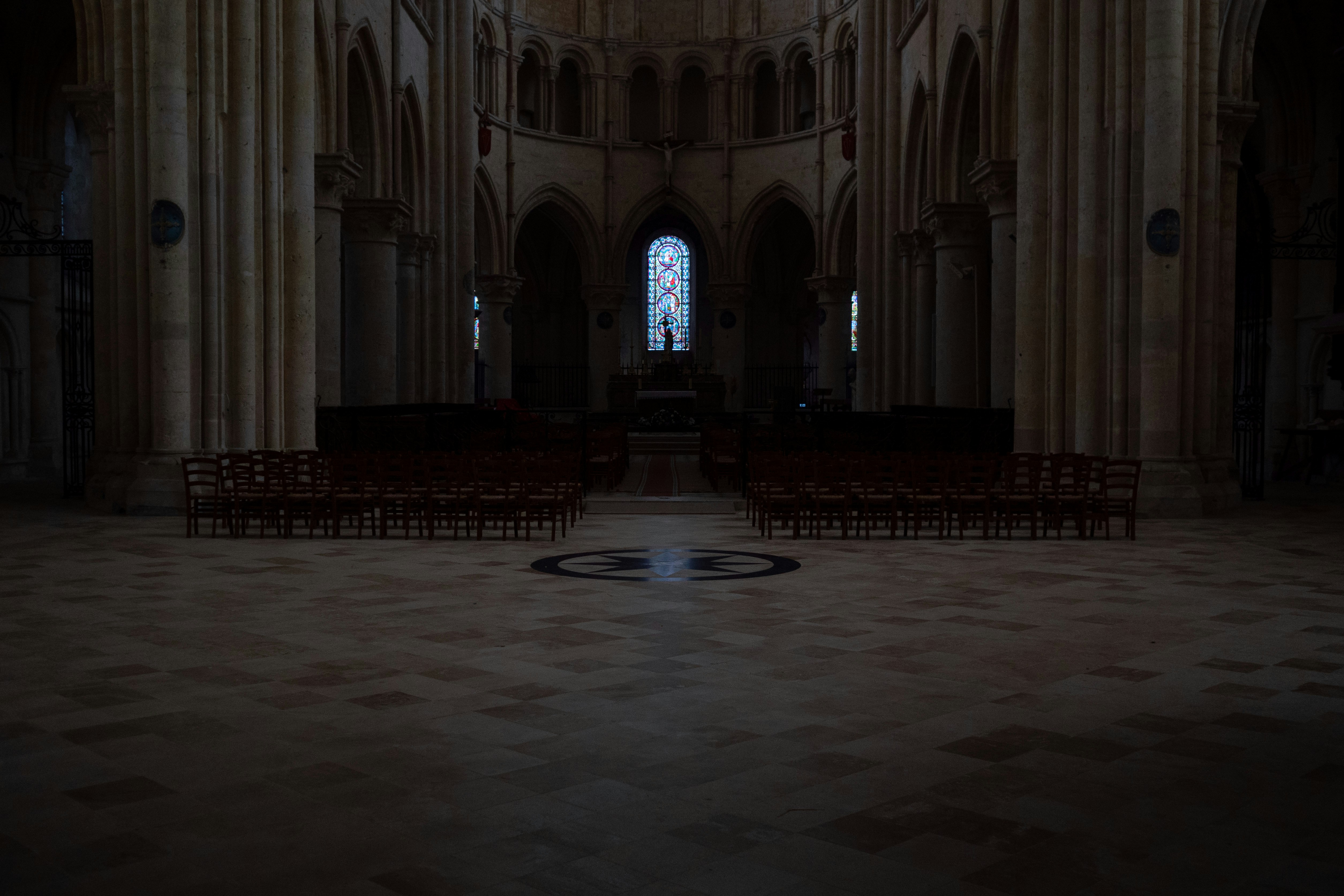 Interior of a grand cathedral with rows of chairs.
