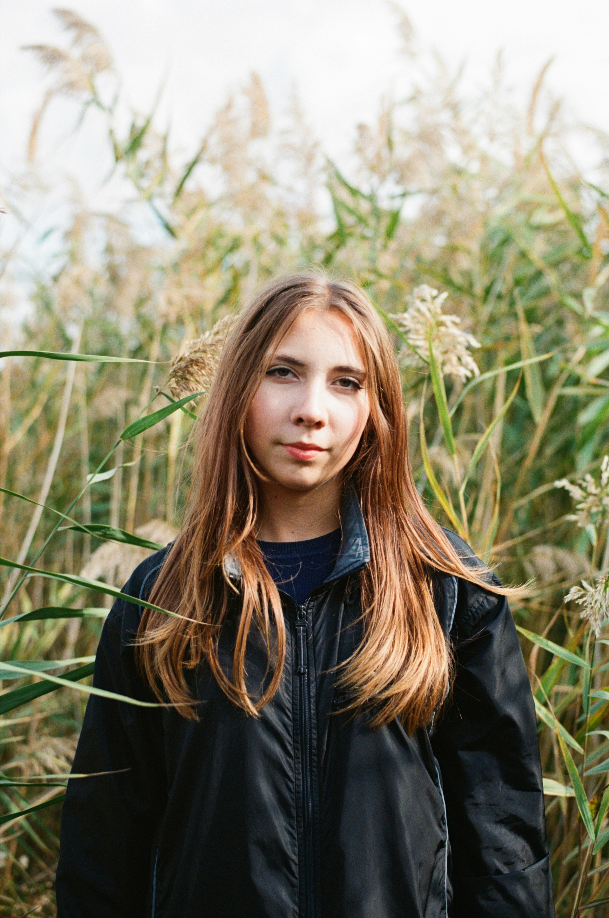 Young woman standing in tall grass