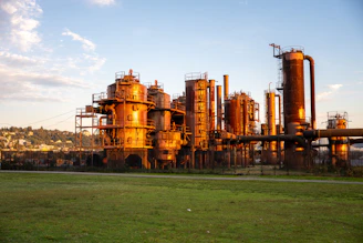 Industrial complex with rusty metal structures at sunset