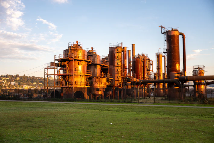 Industrial complex with rusty metal structures at sunset