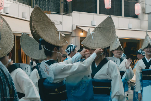 People in traditional japanese straw hats and kimonos
