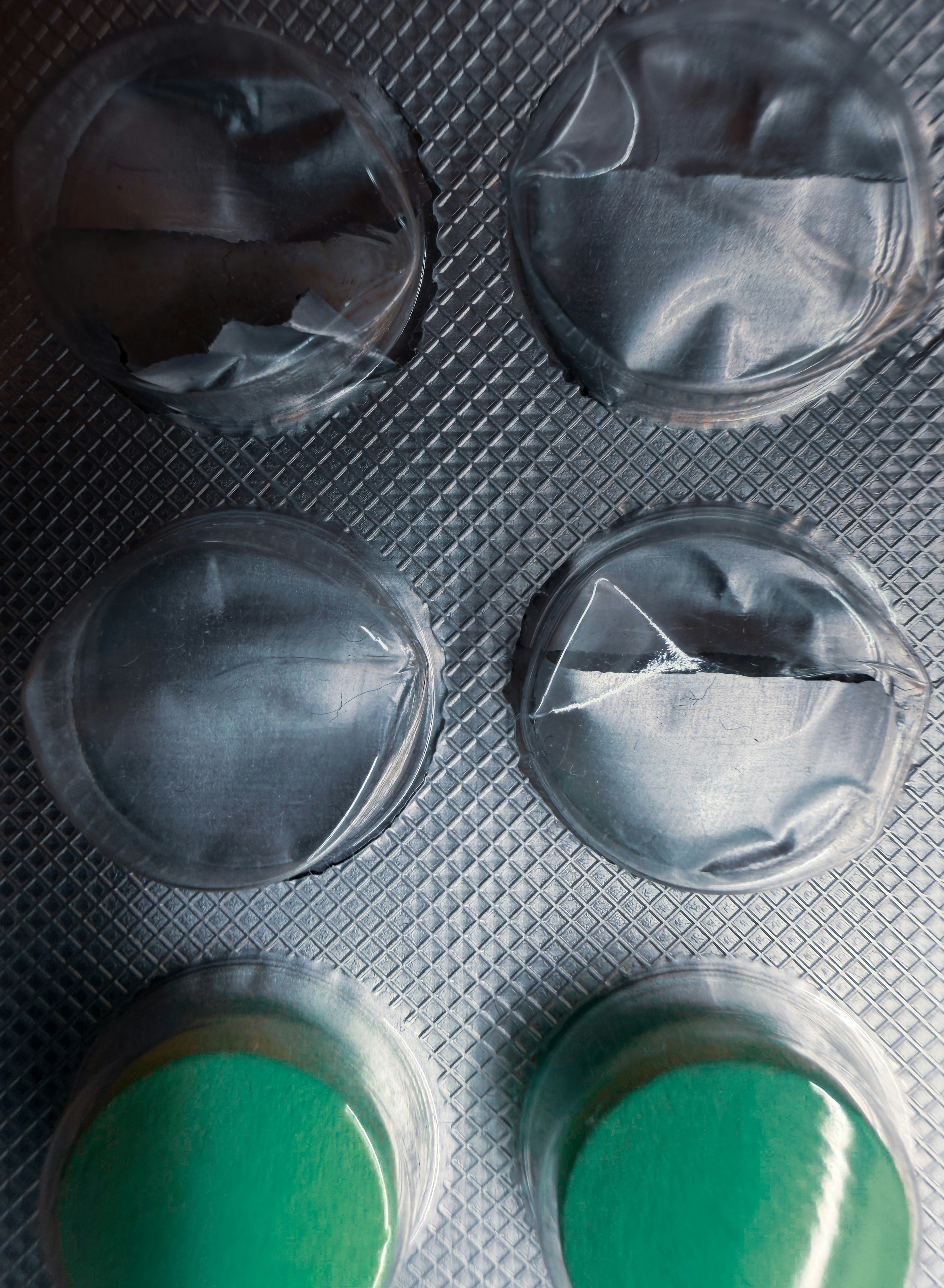Pills in a blister pack with green bottoms