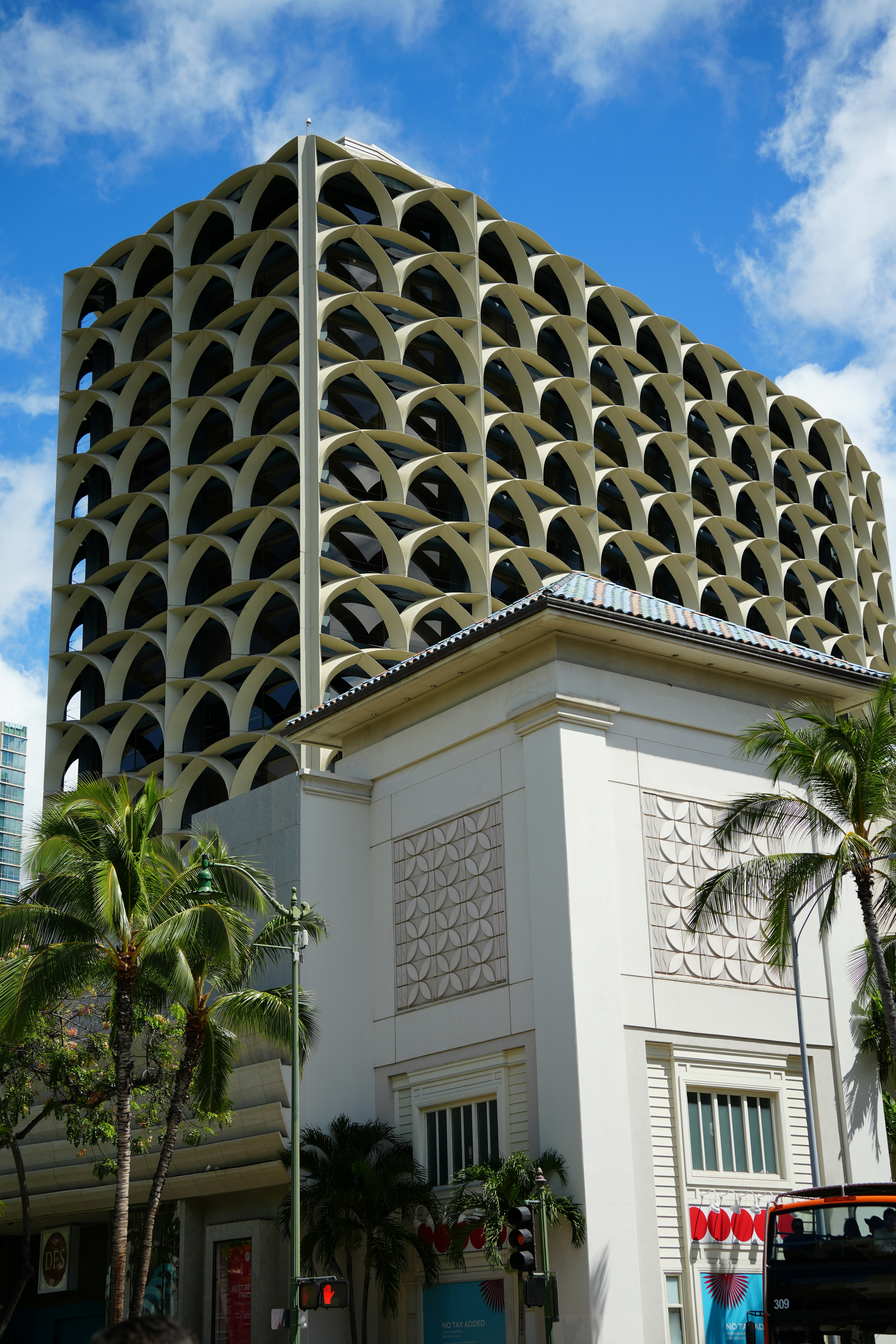 独特なファサードとヤシの木を持つ近代的な建物