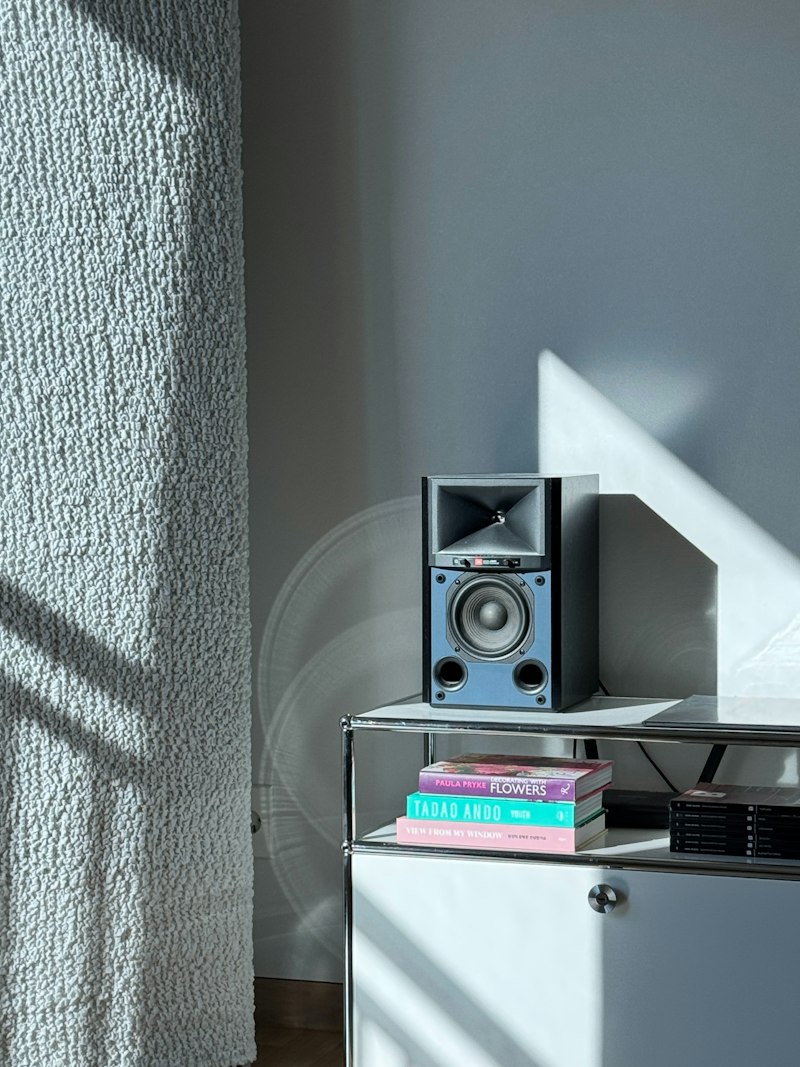 Small bookshelf-style speaker on a shelf