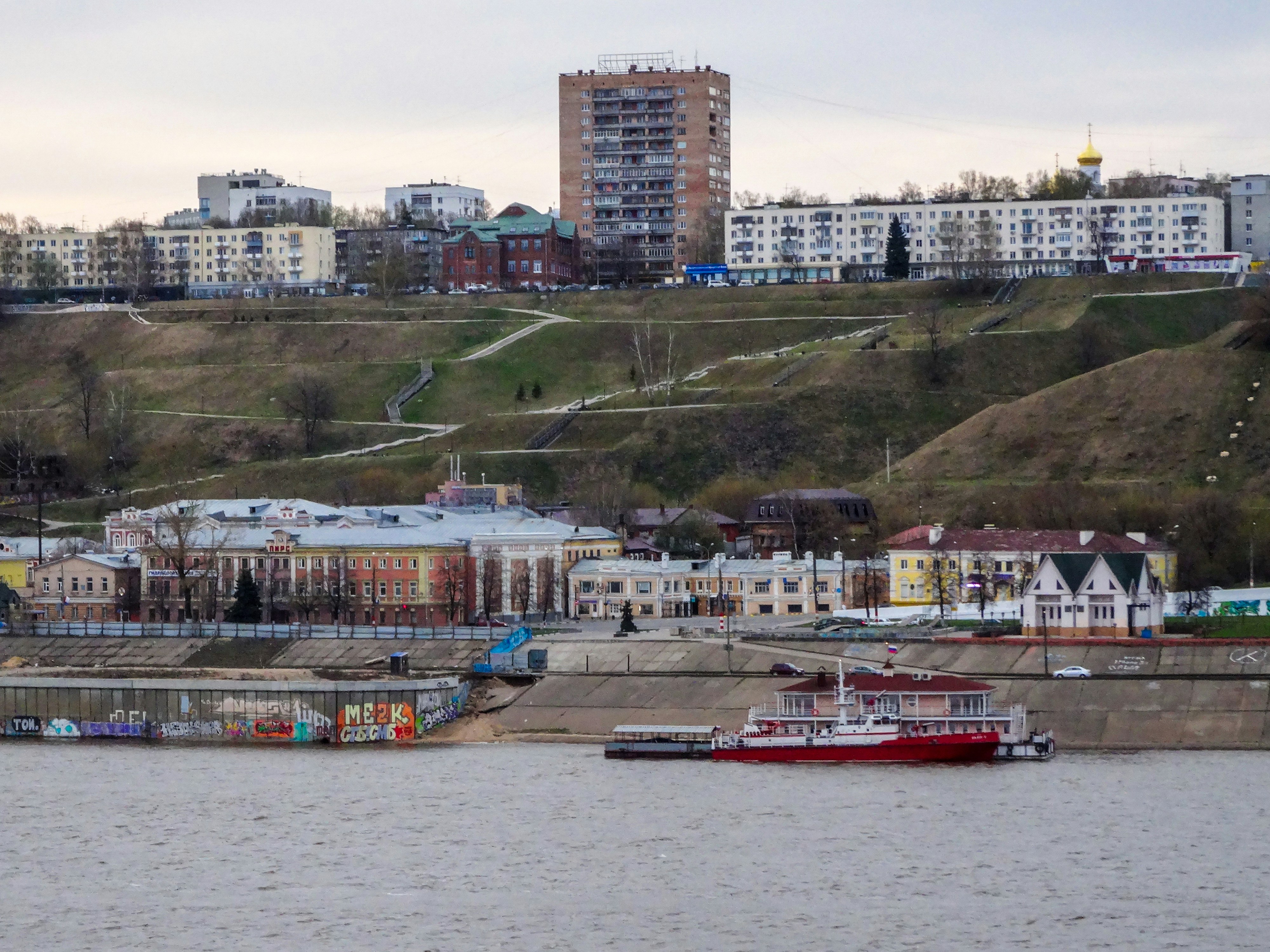 City buildings on a hill overlooking a river.