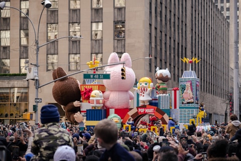Parade float with cartoon characters and balloons.