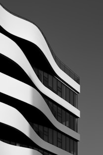 Modern building with curved white facade and windows